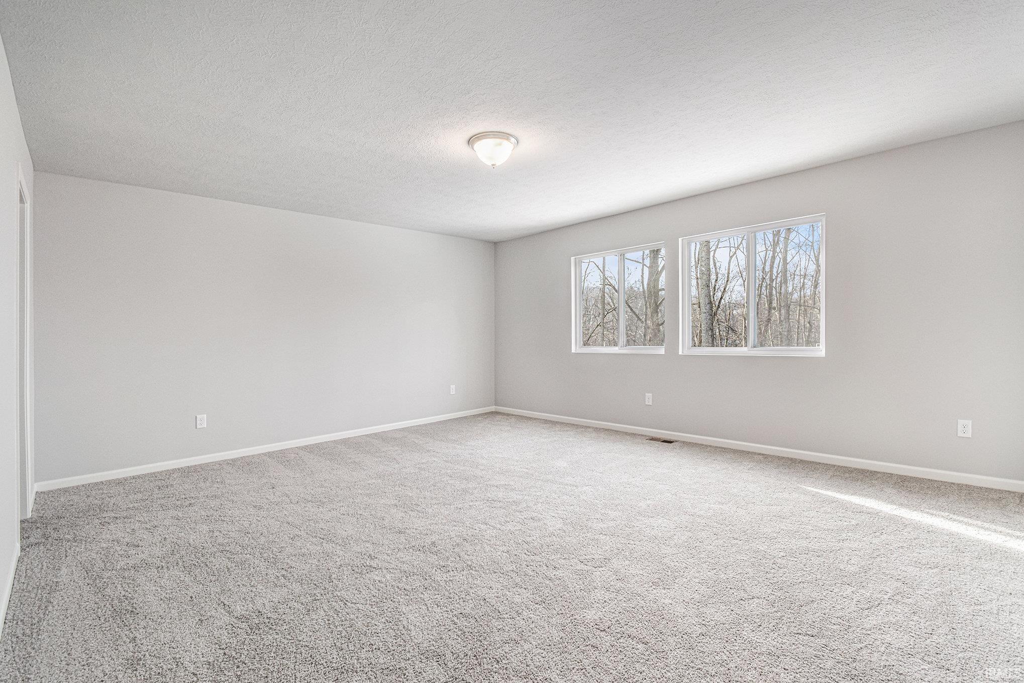 The spacious primary suite includes a private bath and oversized walk-in closet.