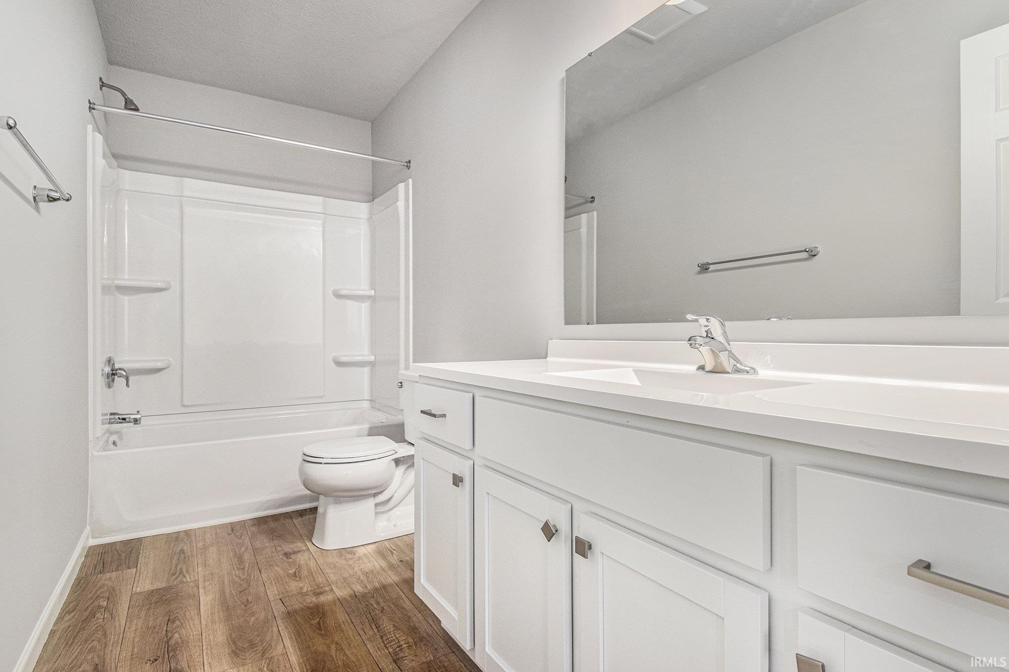 The spacious primary suite includes a private bath and oversized walk-in closet.