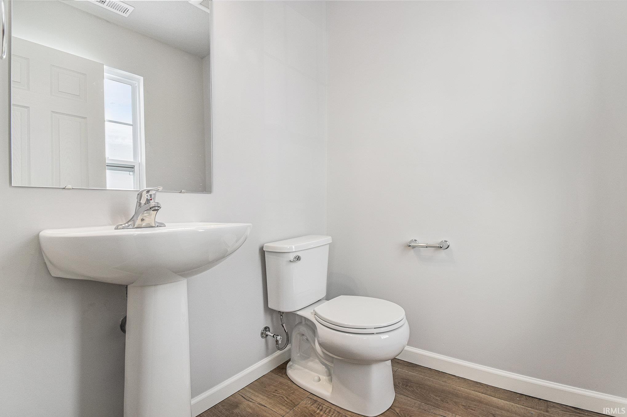 The powder room is located toward the front of the home for privacy.
