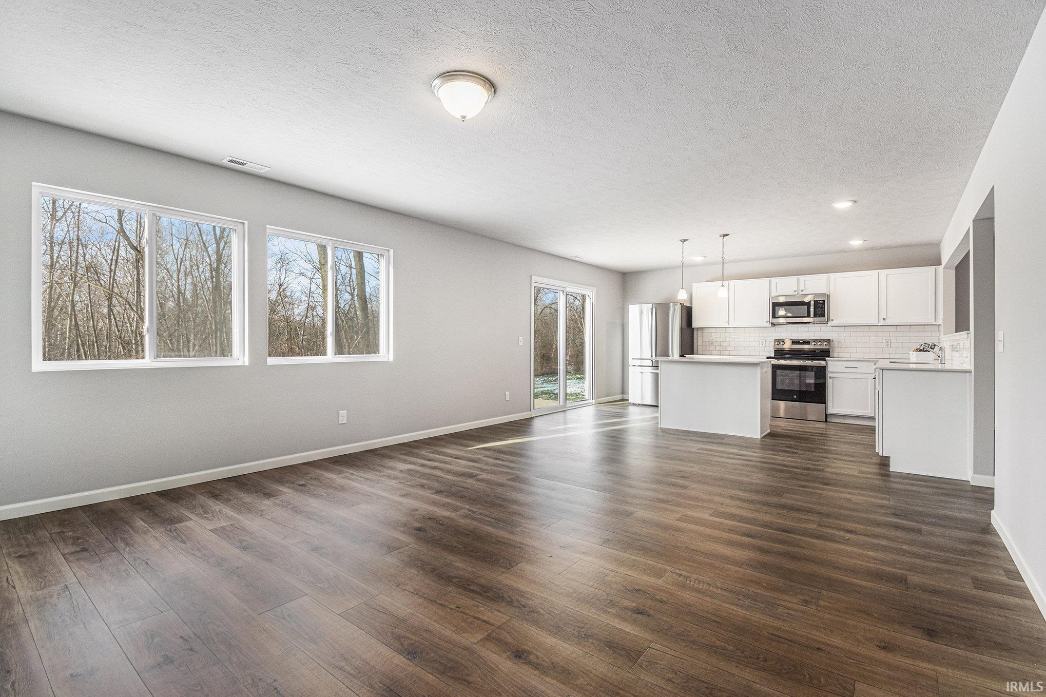 The great room features an abundance of natural lighting and offers open sight lines into the kitchen – perfect for entertaining groups routine activities and functionality.