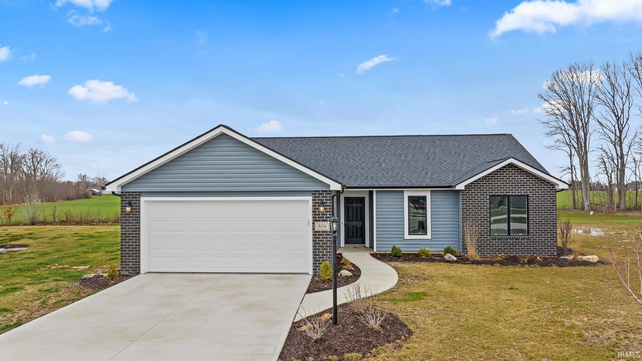 Ranch-style house with brick siding, a front yard, an attached garage, concrete driveway, and a shingled roof