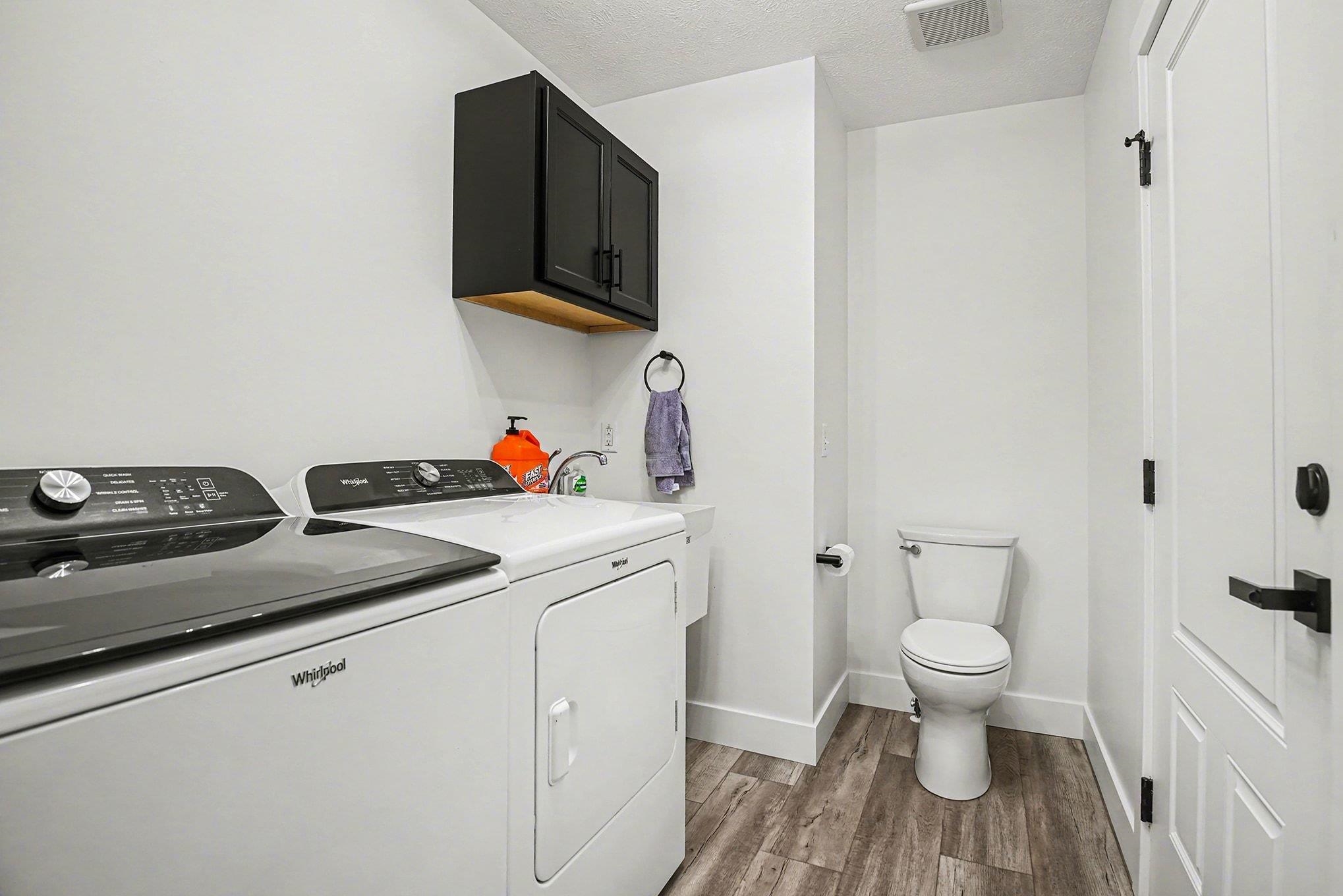 Laundry room featuring light wood-style flooring and independent washer and dryer