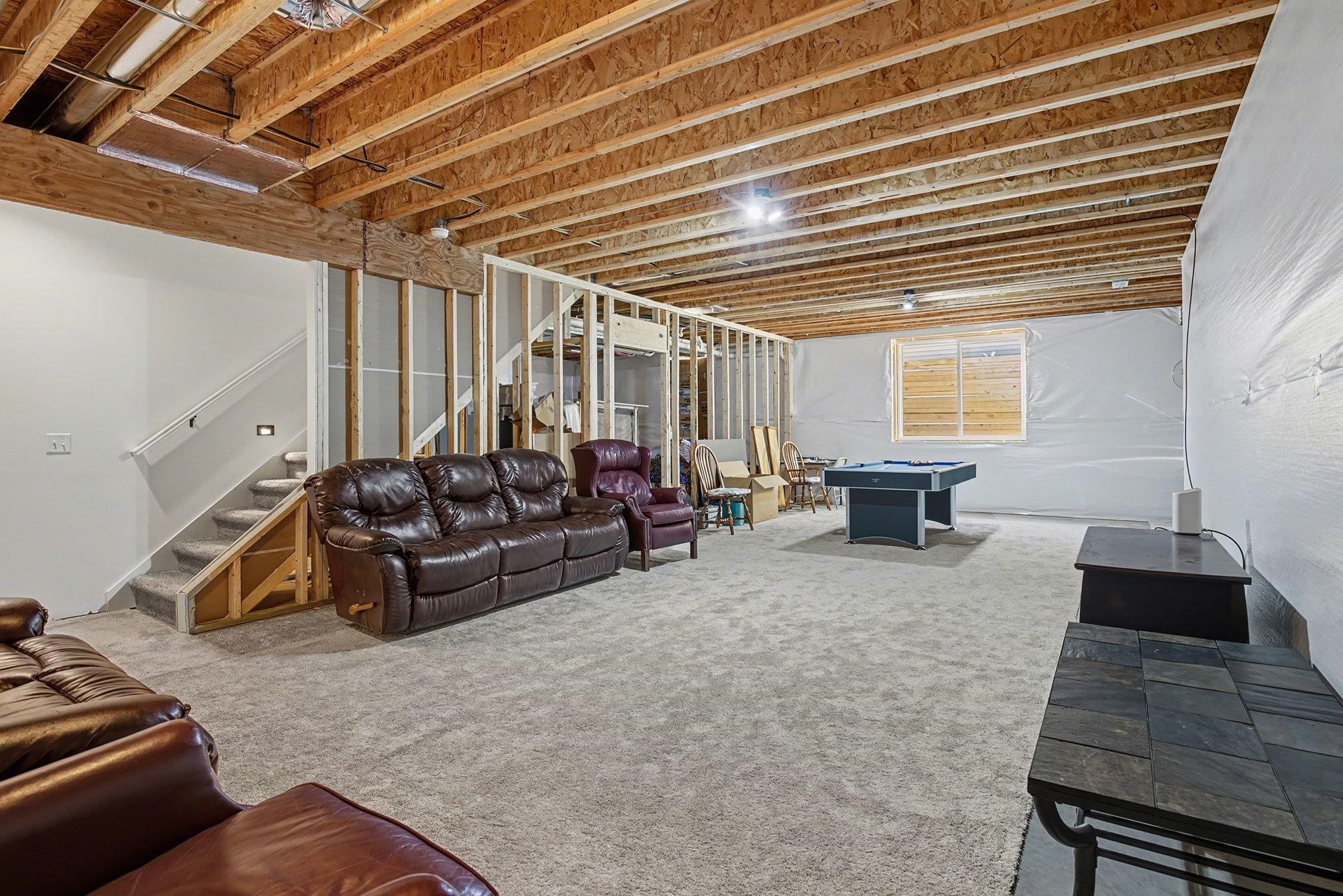 Carpeted living area featuring stairway and billiards
