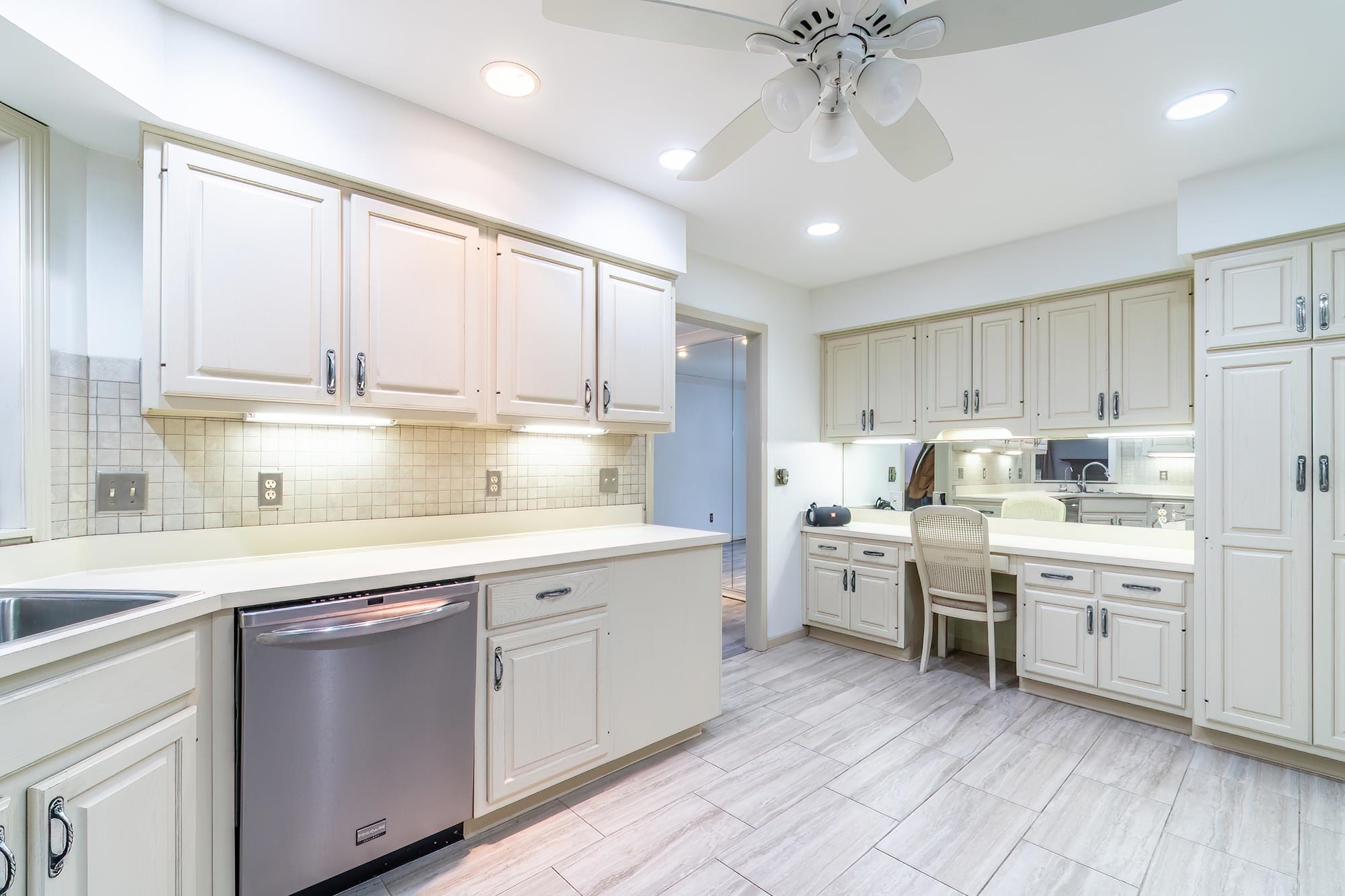 Kitchen featuring light countertops, dishwasher, ceiling fan, decorative backsplash, and recessed lighting