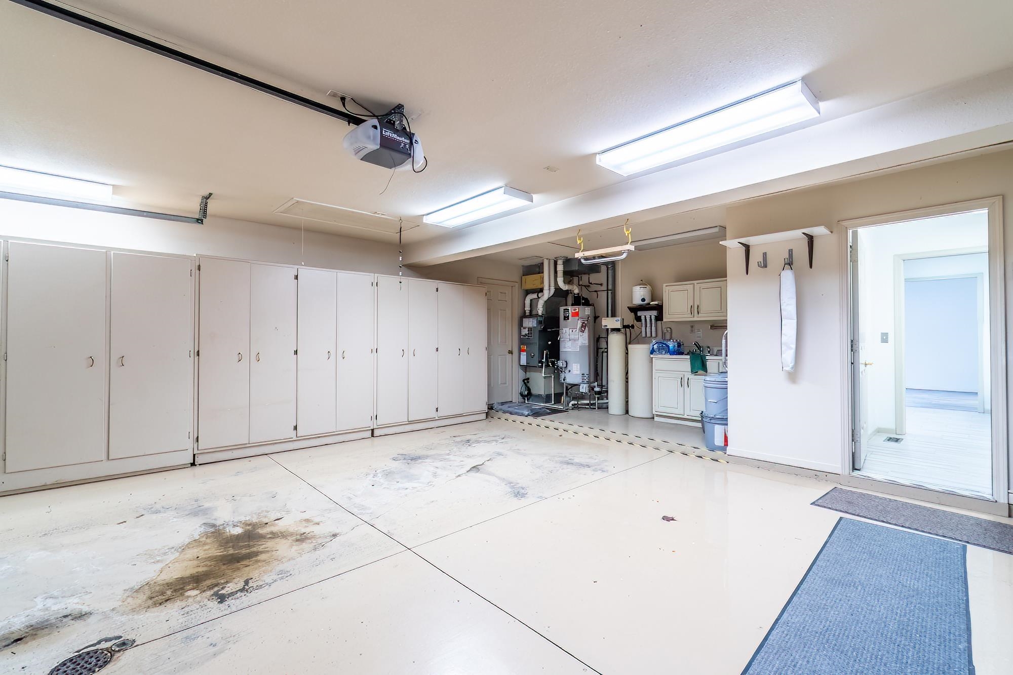 Garage with water heater and a garage door opener