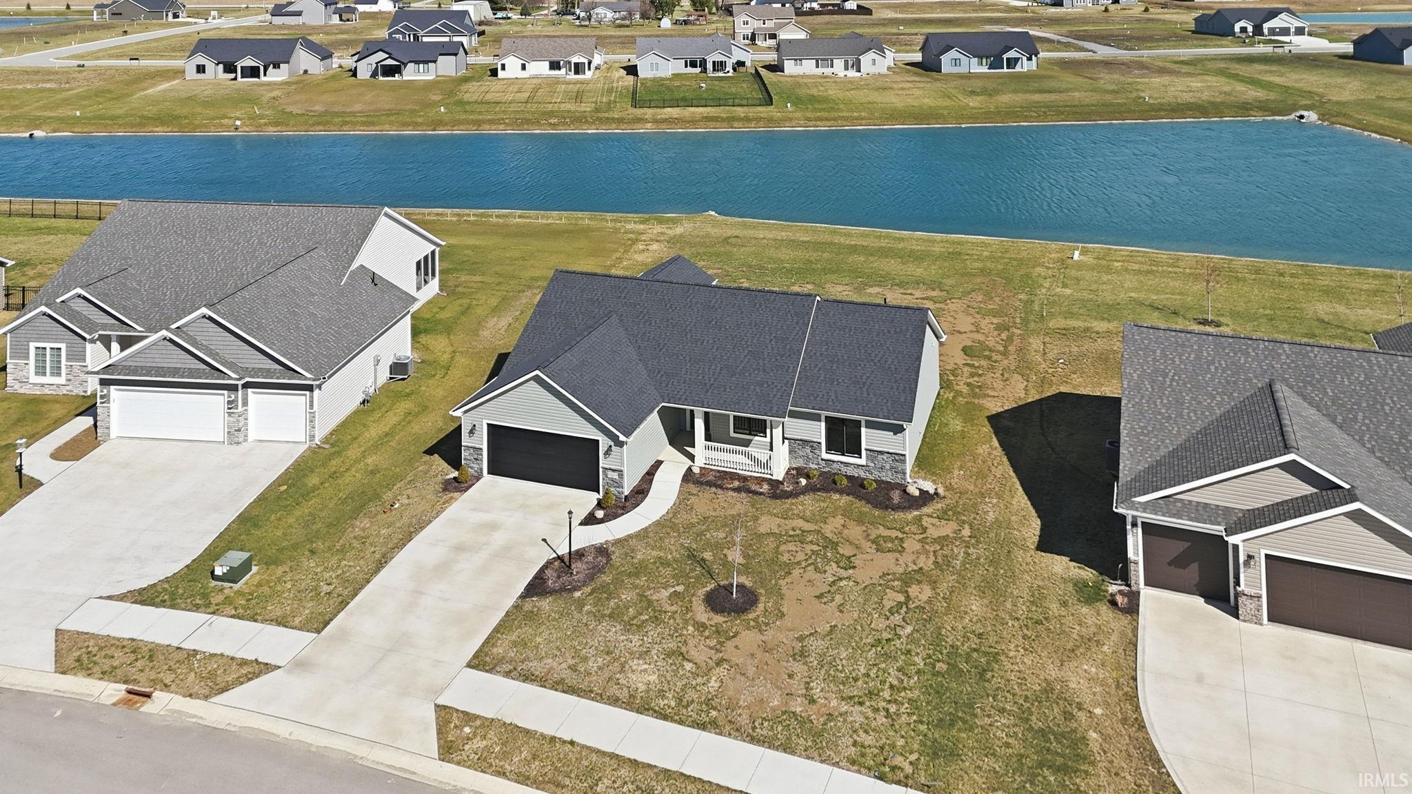 Aerial perspective of suburban area with a large body of water