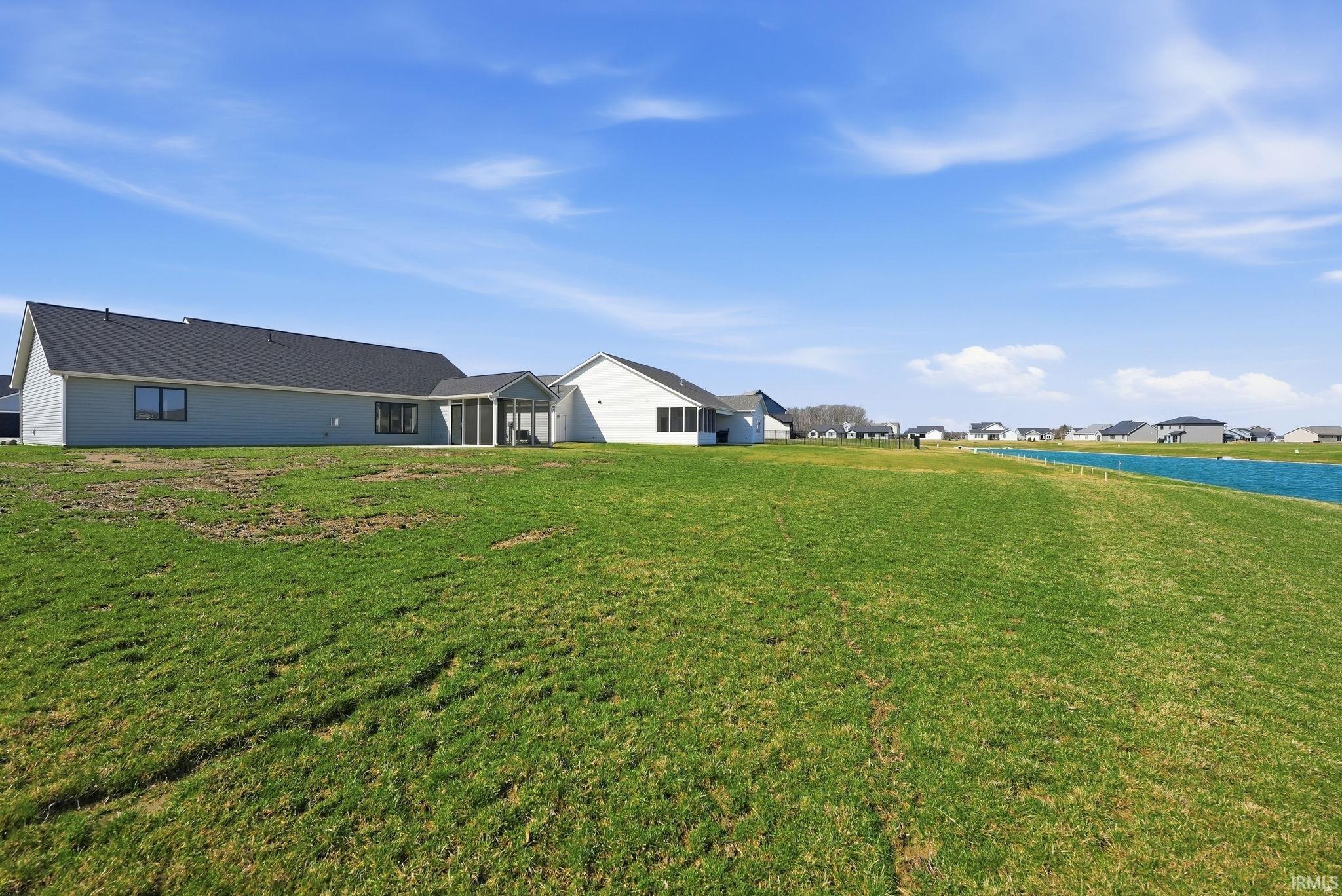 View of green lawn featuring a residential view