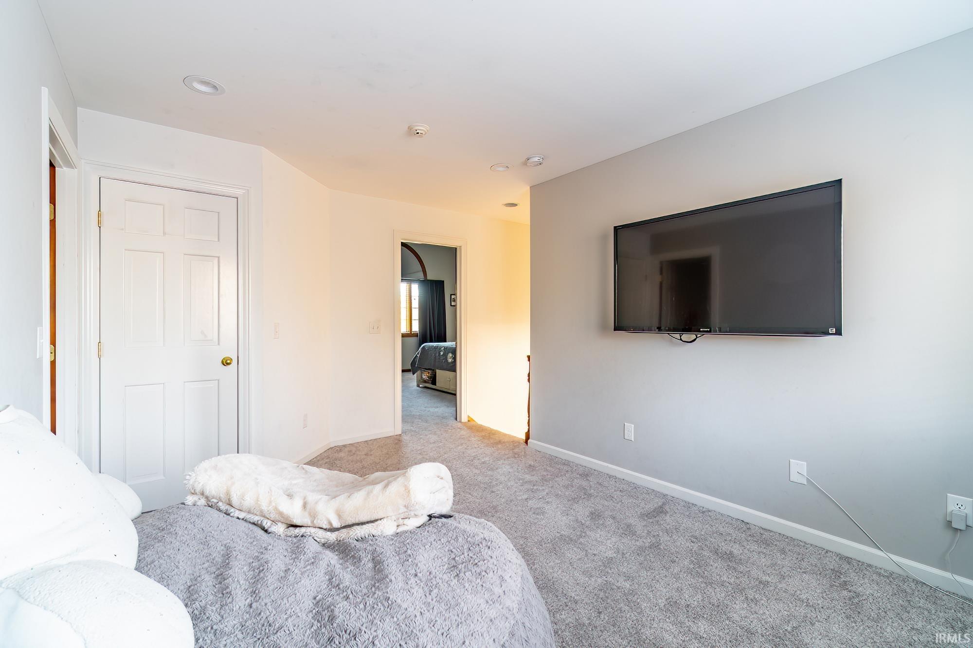 Carpeted living area with baseboards