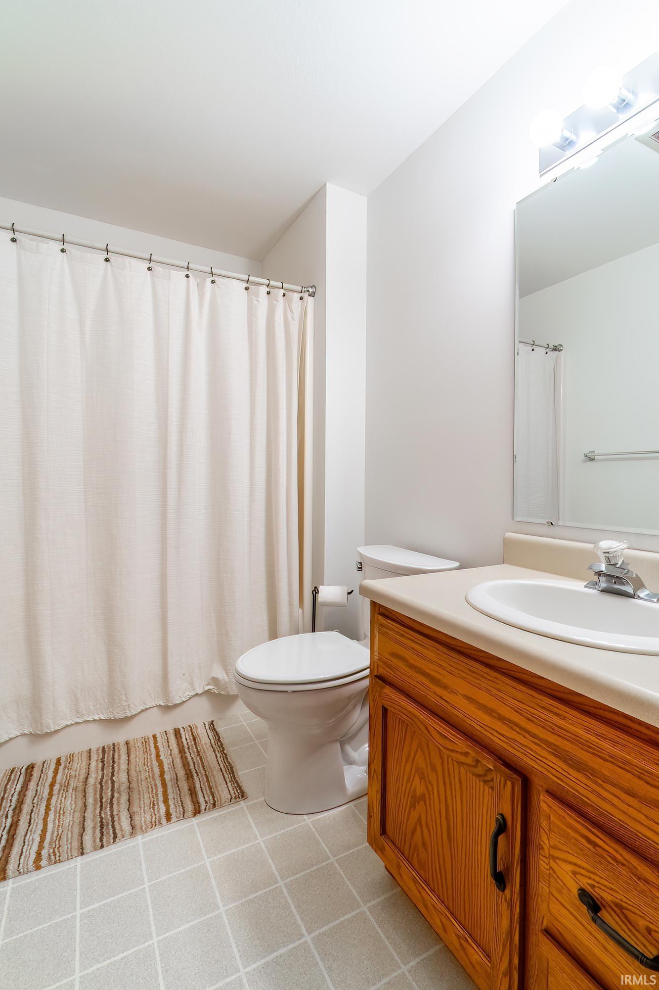 Full bathroom featuring vanity and toilet