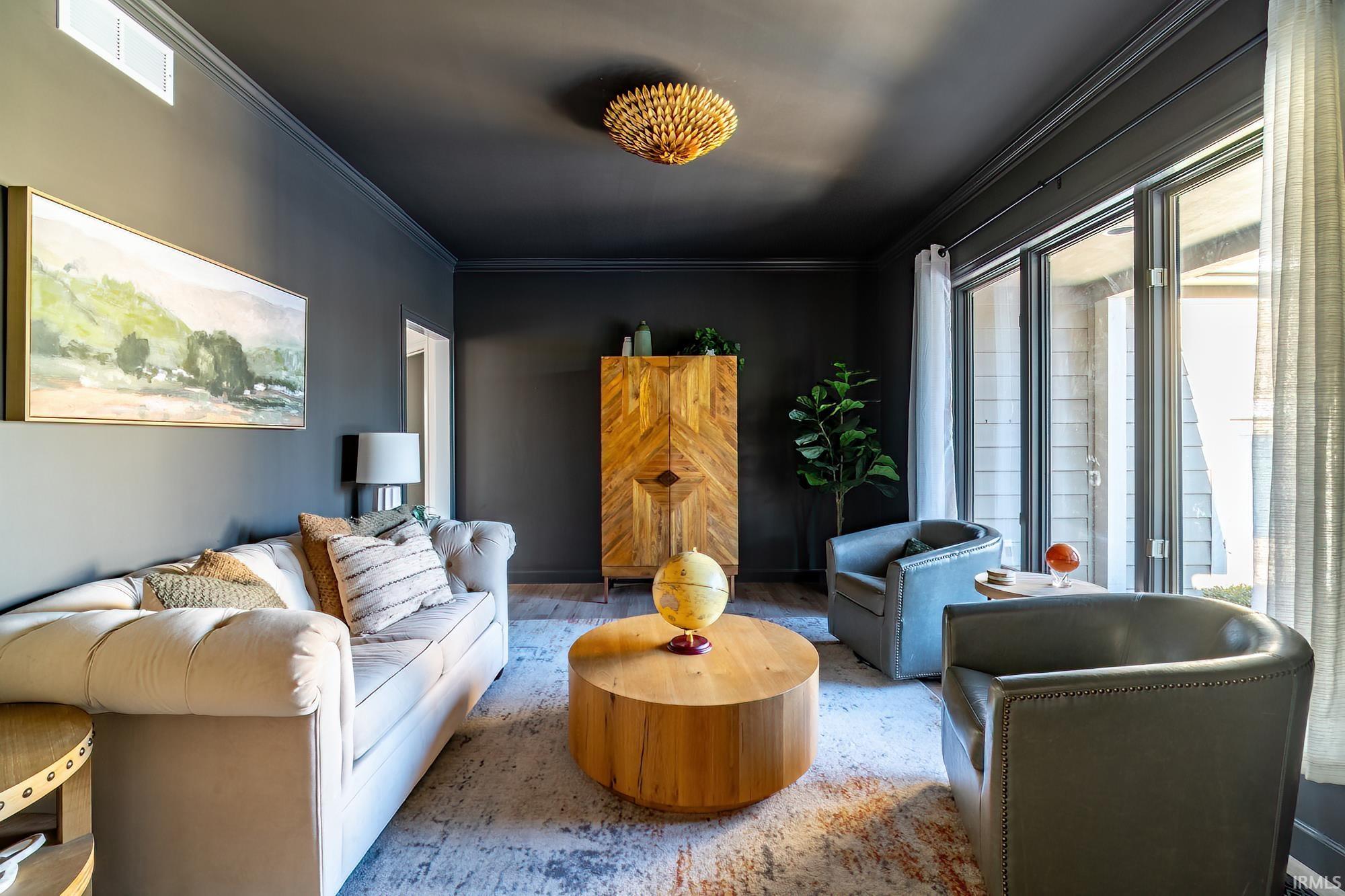 Sitting room featuring ornamental molding and wood finished floors