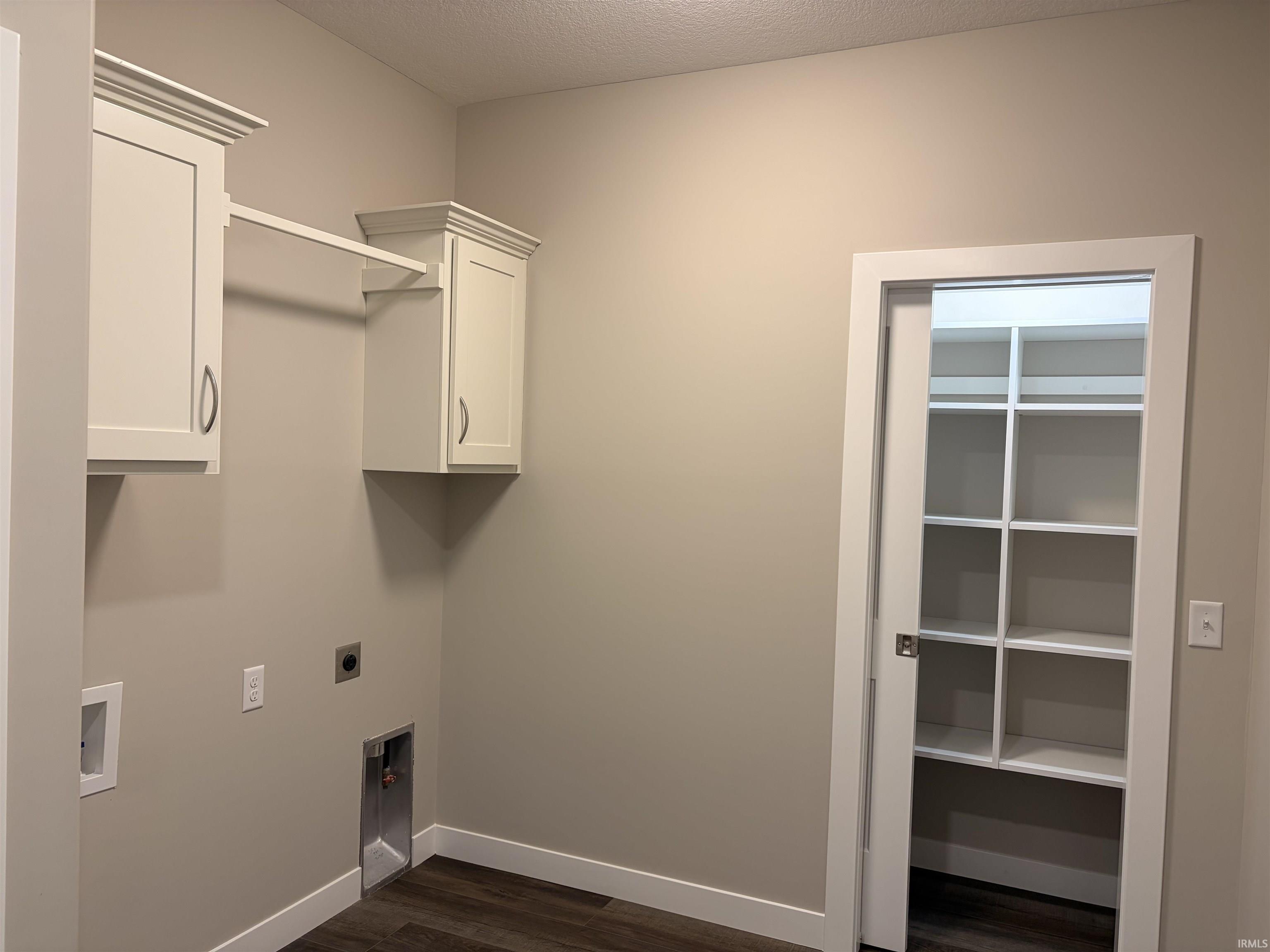 Washroom with cabinet space, closet with pocket door, LVP flooring, electric or gas dryer hookup and locker space as you enter from the garage.