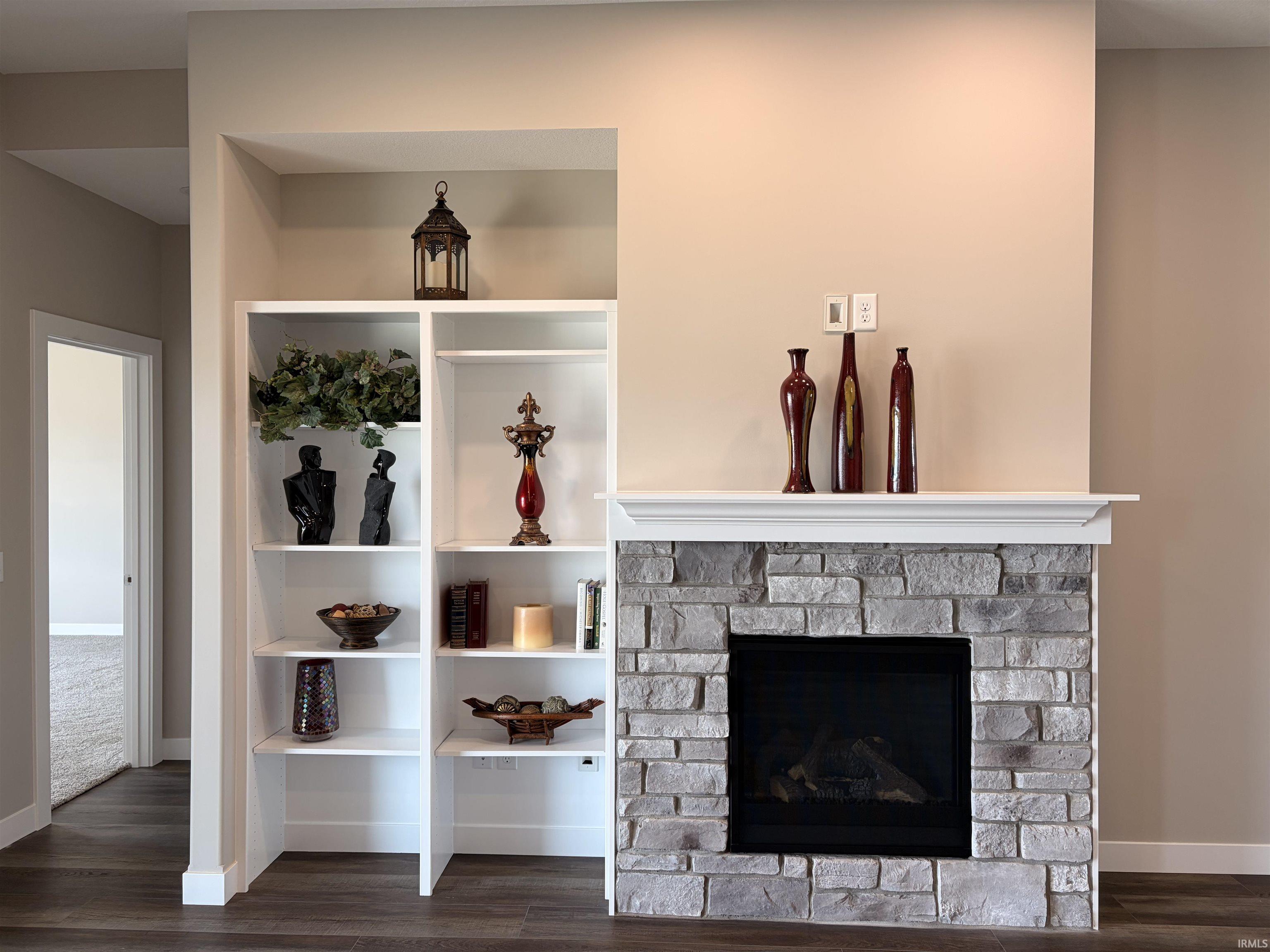 Detailed view of wood finished floors and a fireplace