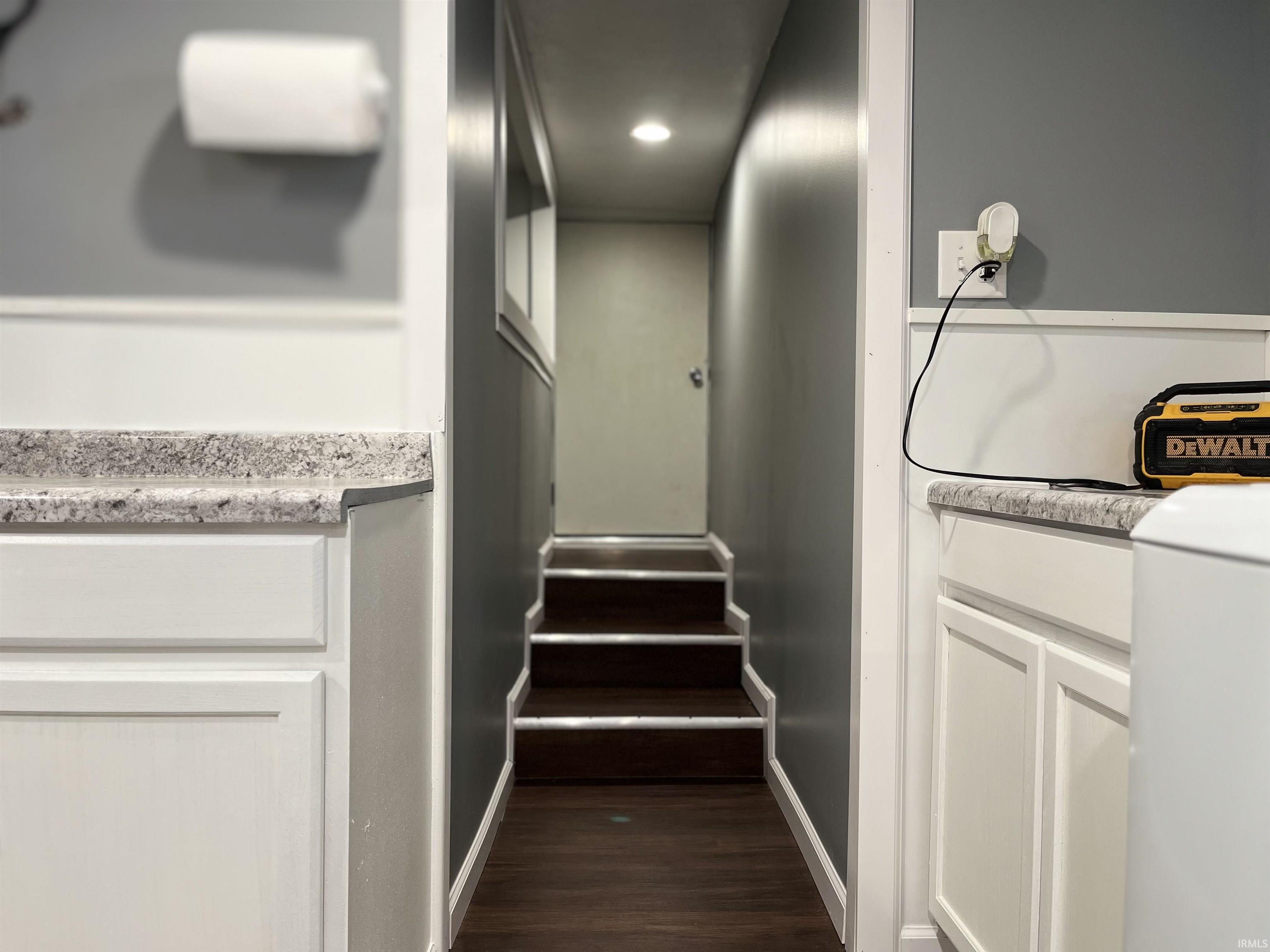 Basement Egress Door. Stairway featuring recessed lighting and wood finished floors