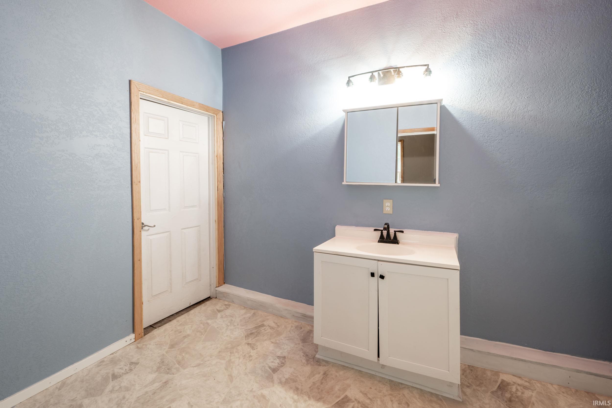Bathroom featuring vanity and light floors