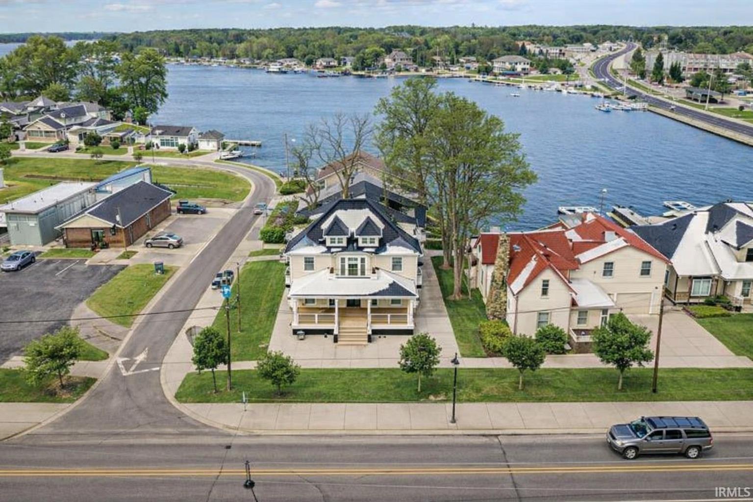 Aerial perspective of suburban area featuring a large body of water