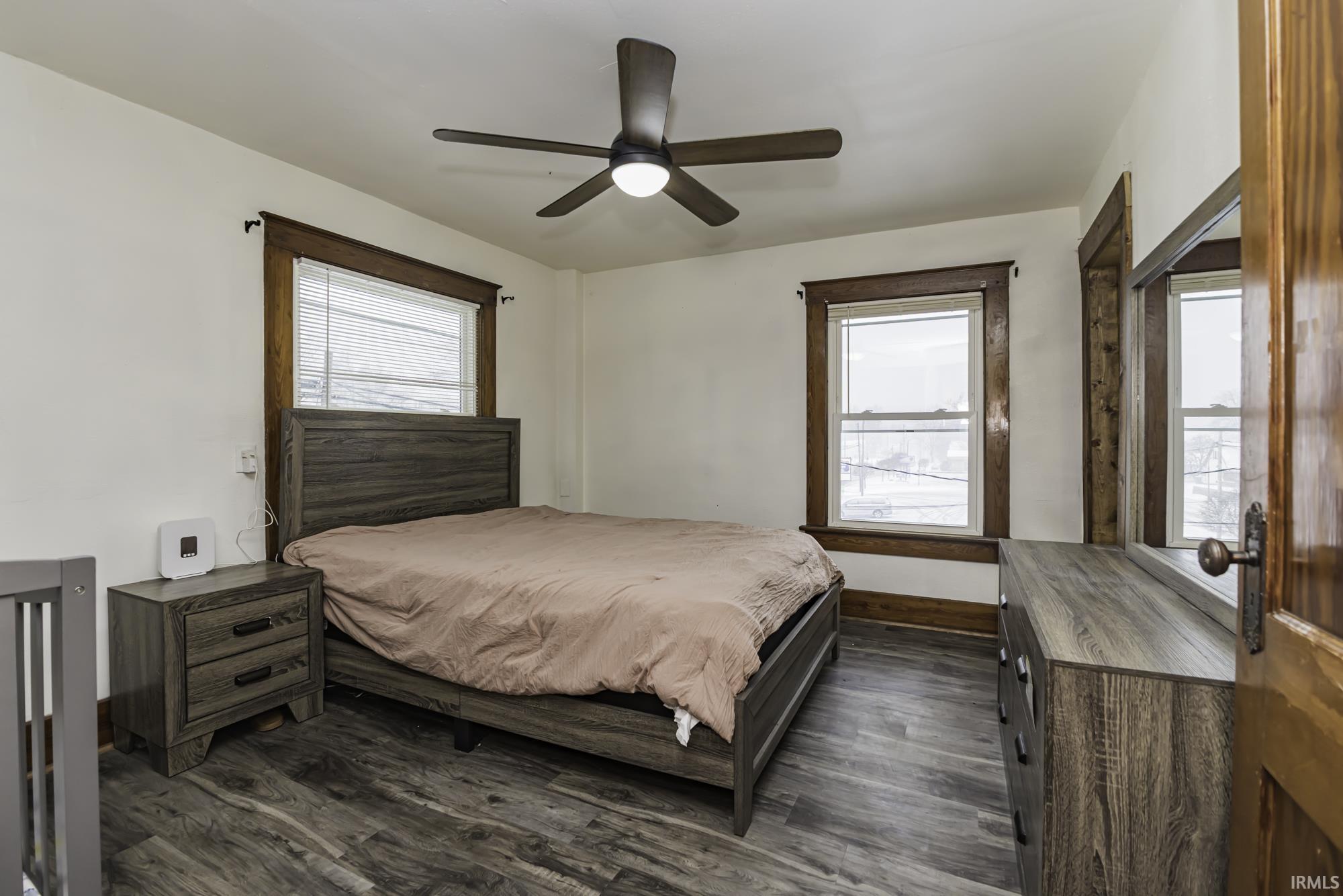 Bedroom featuring a ceiling fan and dark wood-type flooring