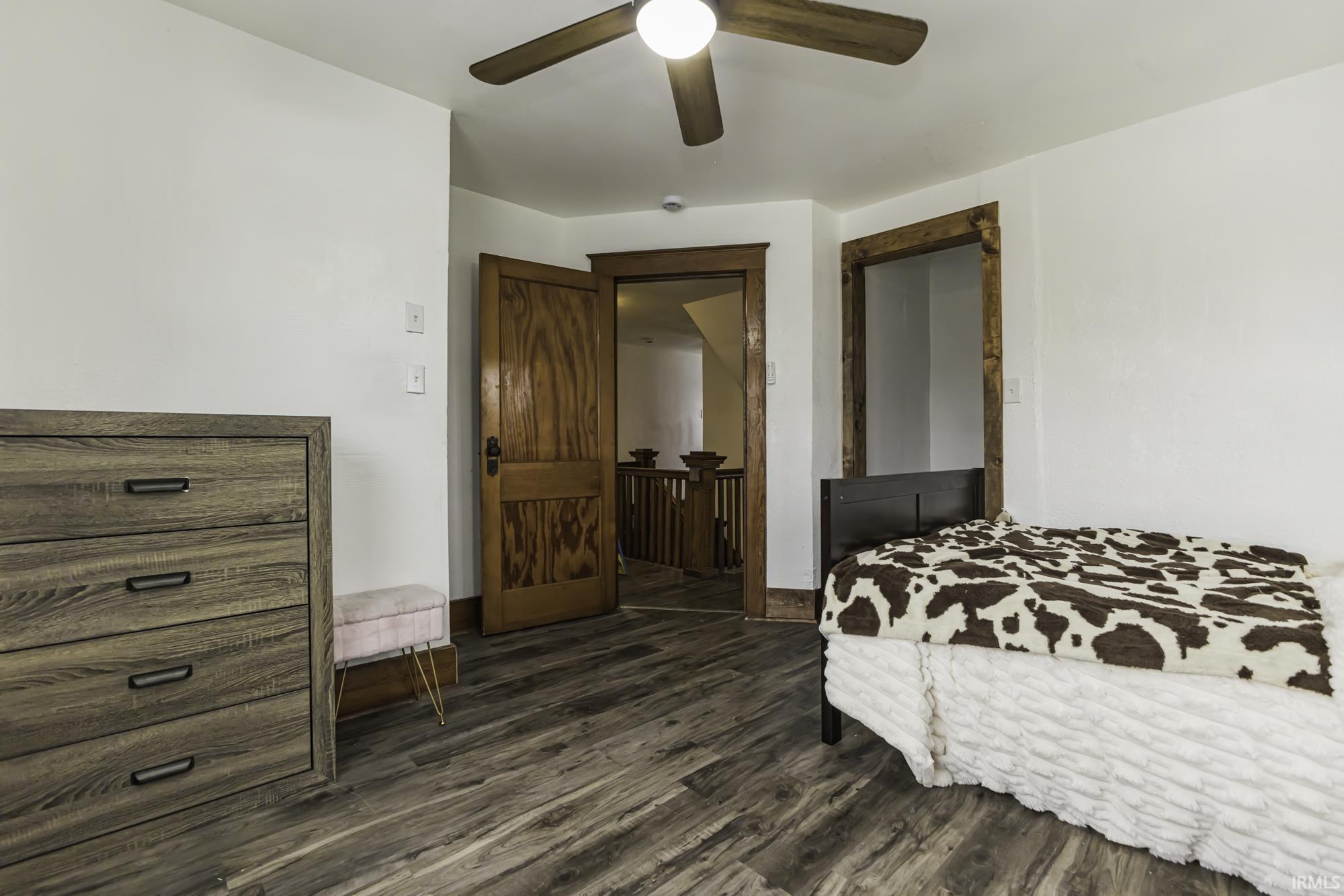 Bedroom featuring dark wood-type flooring and a ceiling fan