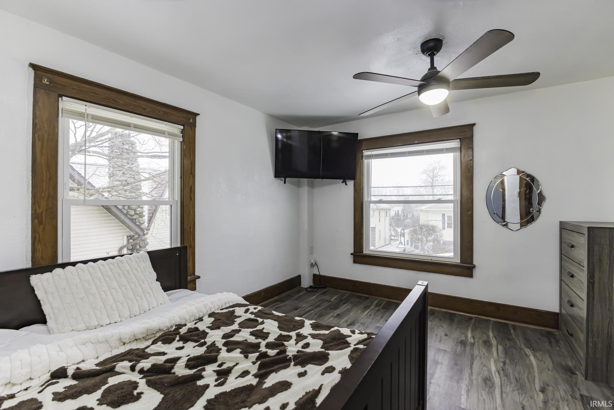 Bedroom featuring dark wood finished floors and a ceiling fan