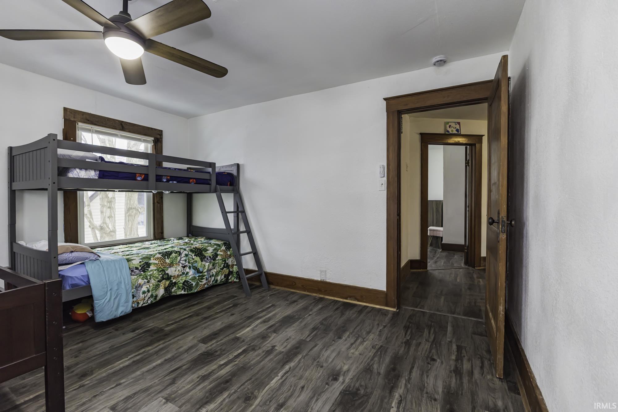 Bedroom featuring dark wood-style flooring and a ceiling fan