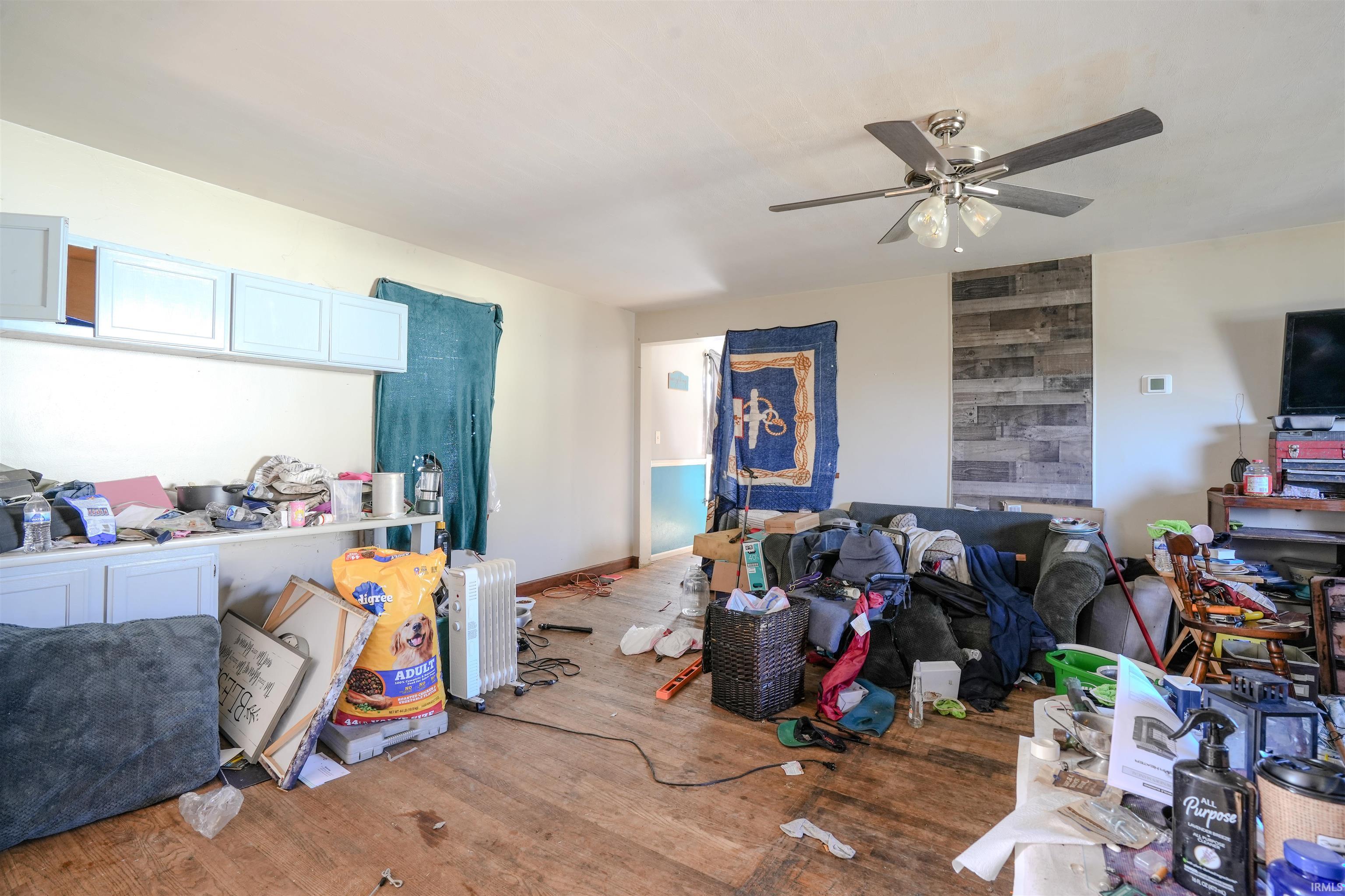 Living area with wood finished floors and ceiling fan