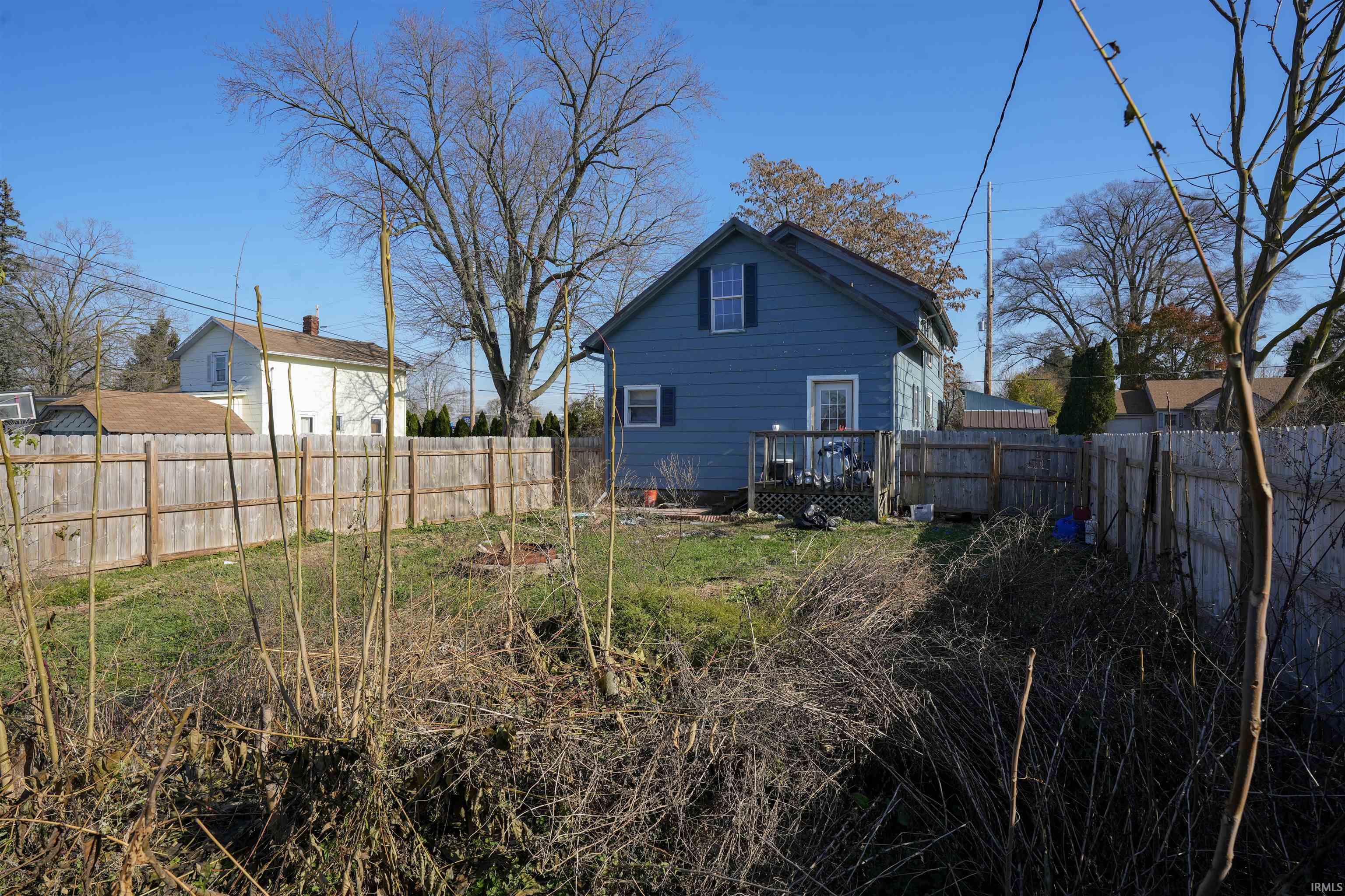Rear view of house with a deck and a fenced backyard