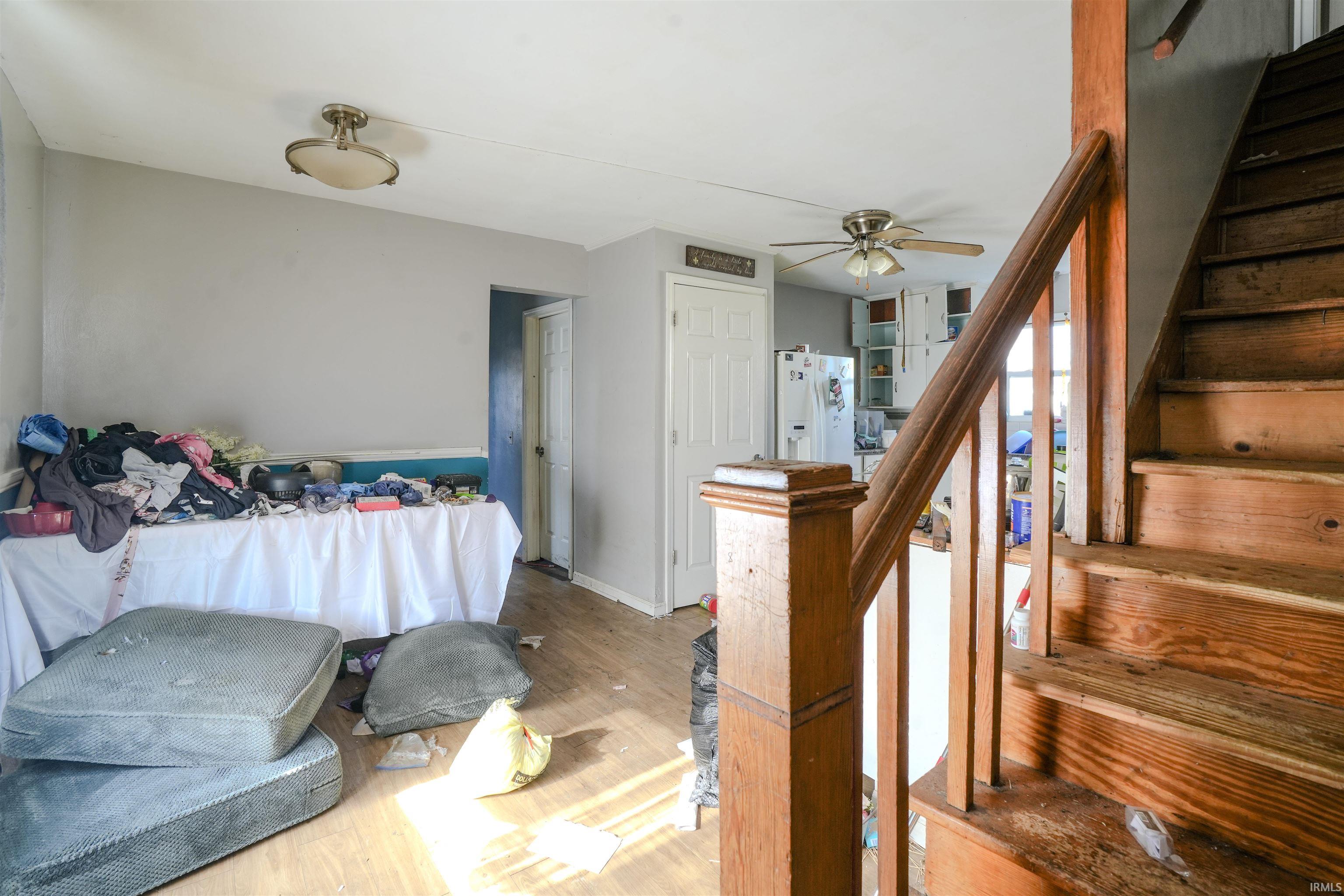 Staircase with wood finished floors and baseboards