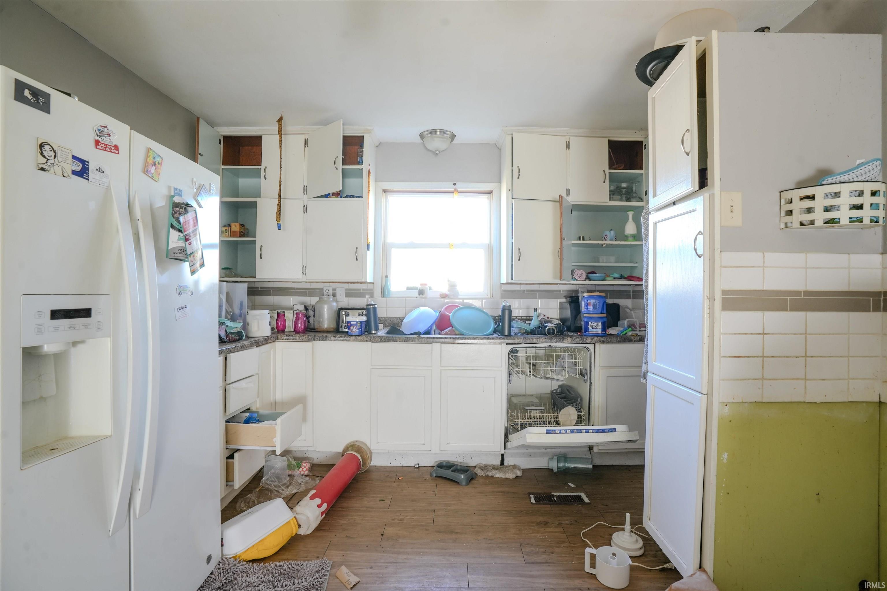 Kitchen with open shelves, white refrigerator with ice dispenser, white cabinets, and dark wood finished floors