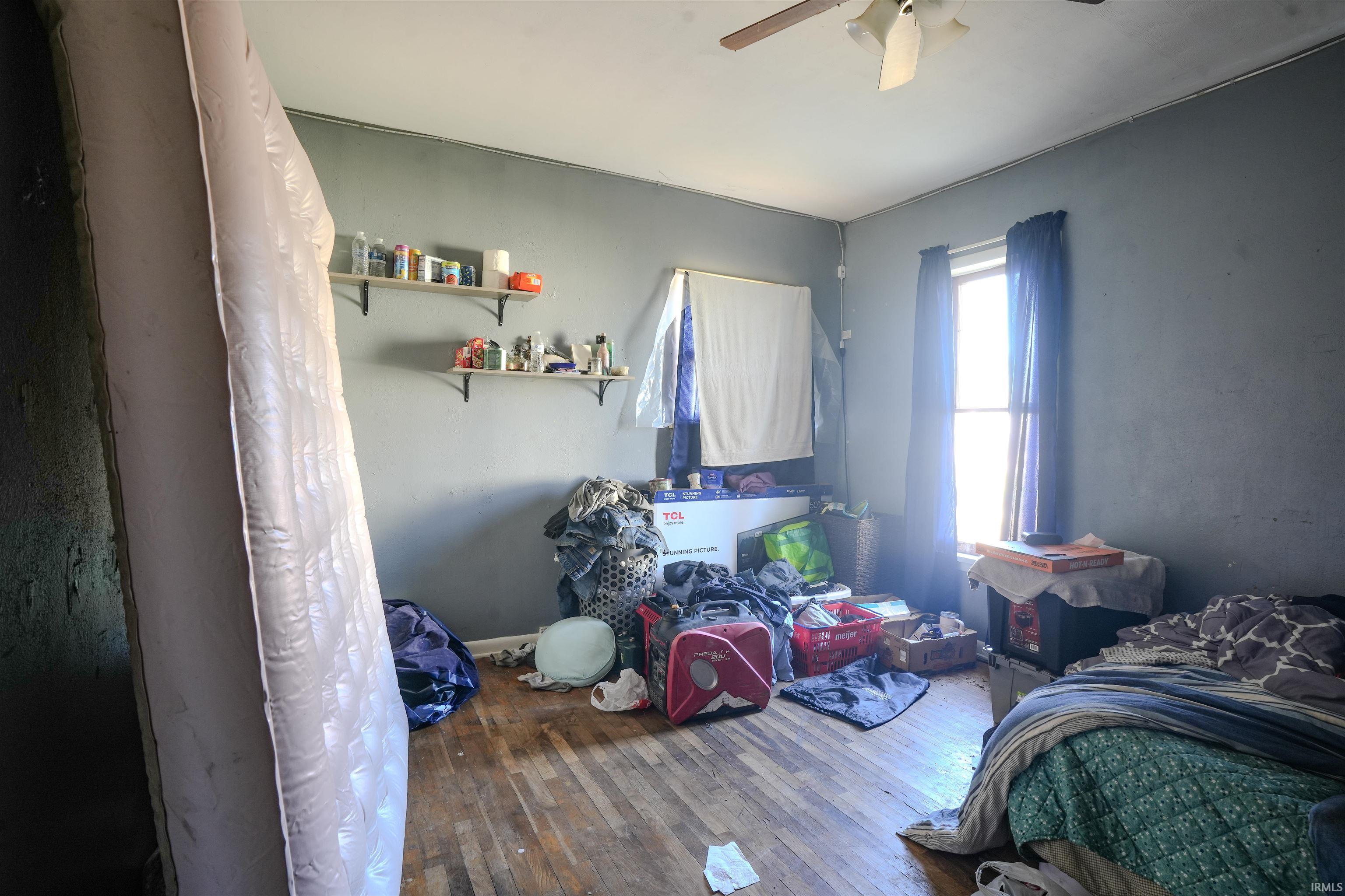 Bedroom featuring wood-type flooring and a ceiling fan