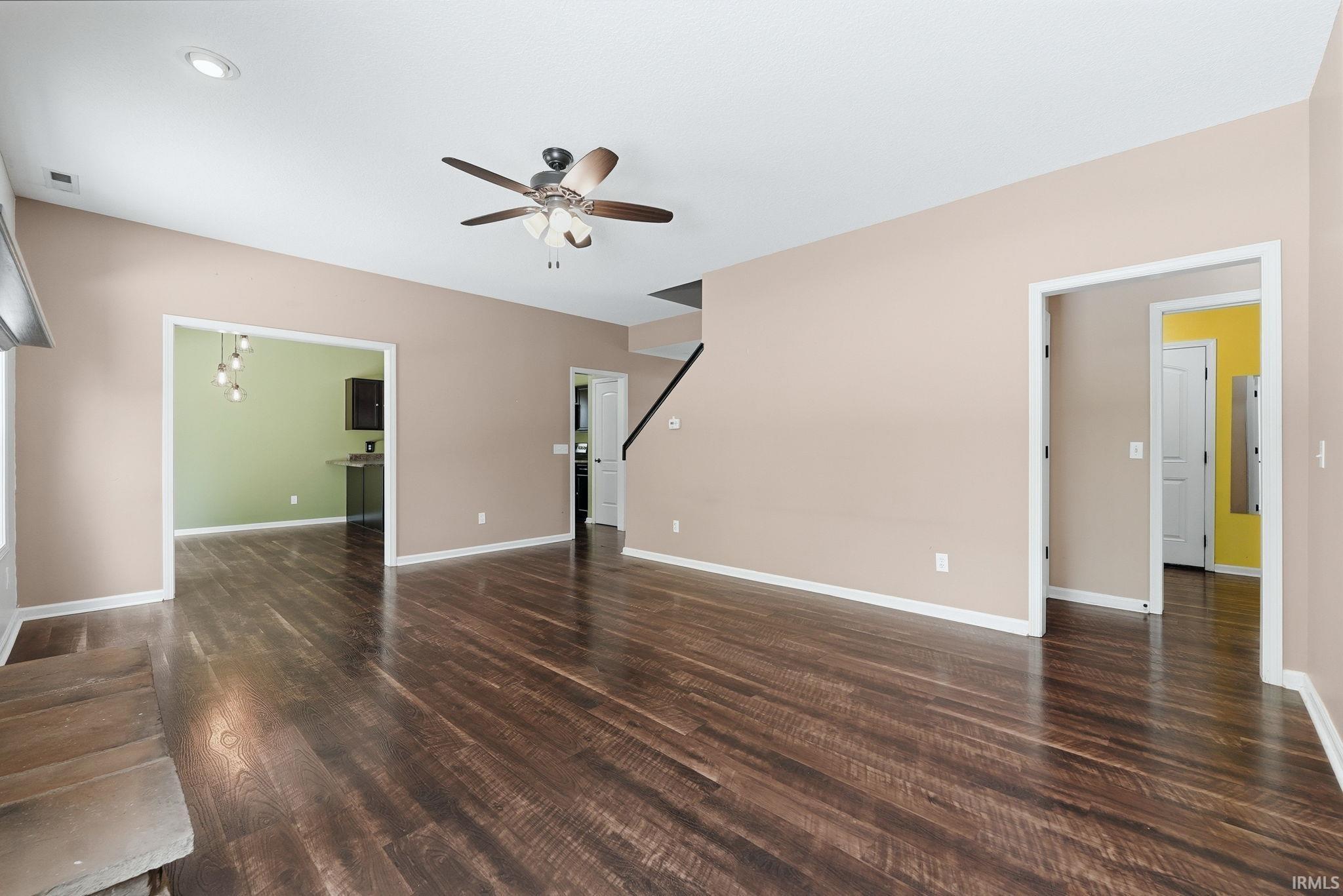 Spacious interior featuring wood-finish flooring, recessed lighting, and a ceiling fan