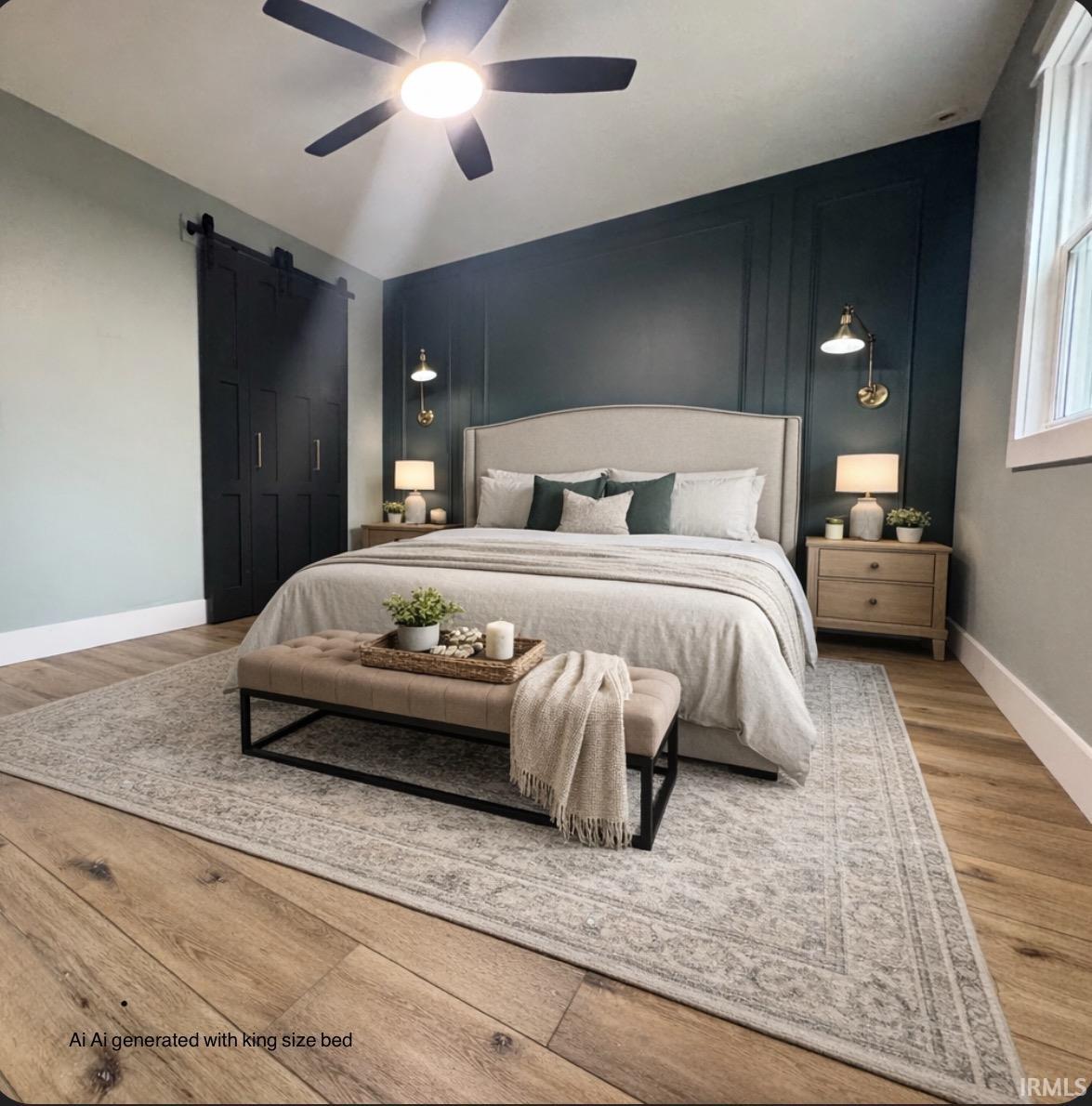 Bedroom featuring a barn door, an accent wall, a ceiling fan, wood finished floors, and a decorative wall