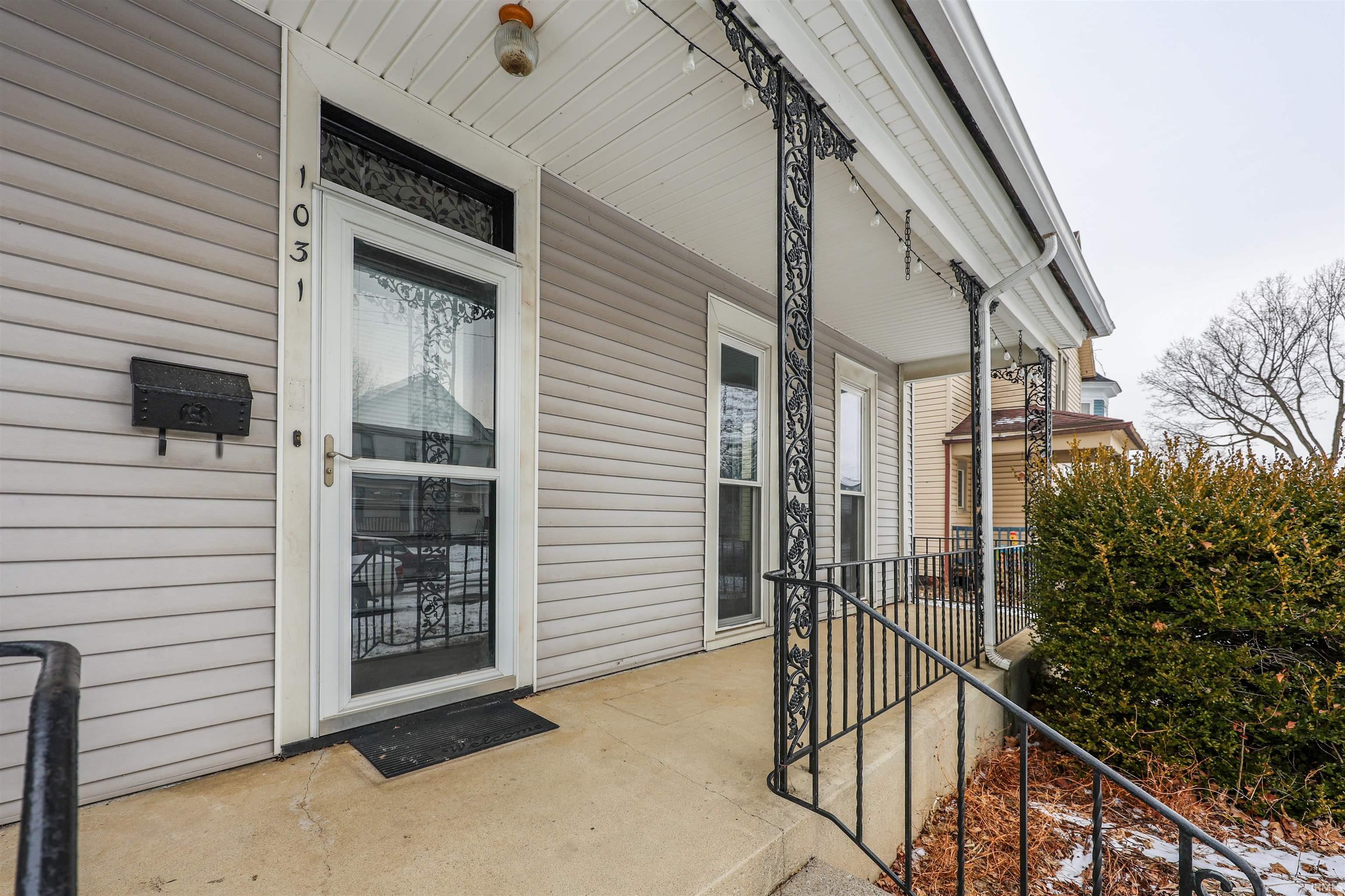 View of exterior entry with a porch