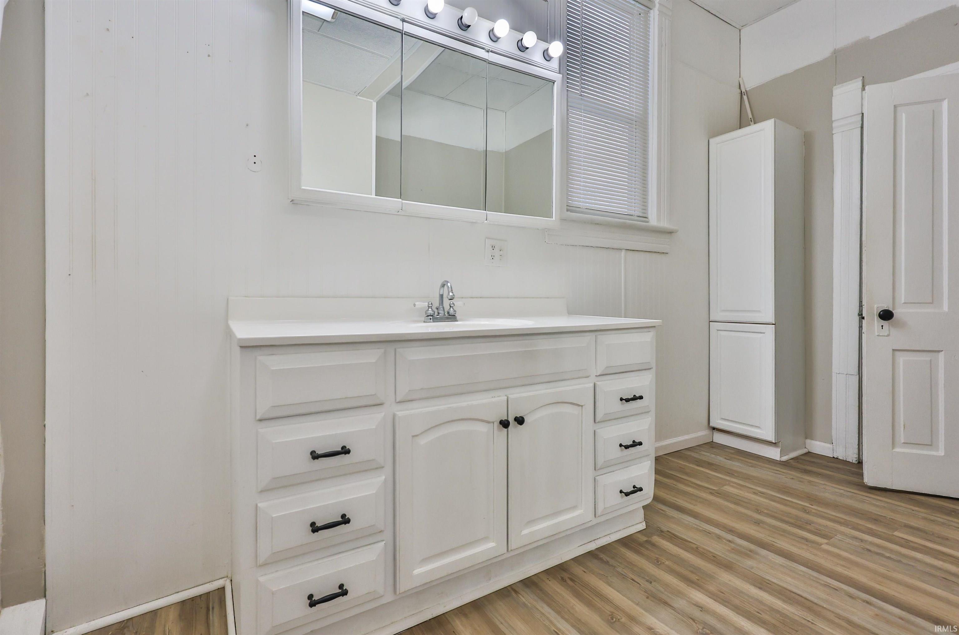 Bathroom with vanity and light wood-type flooring