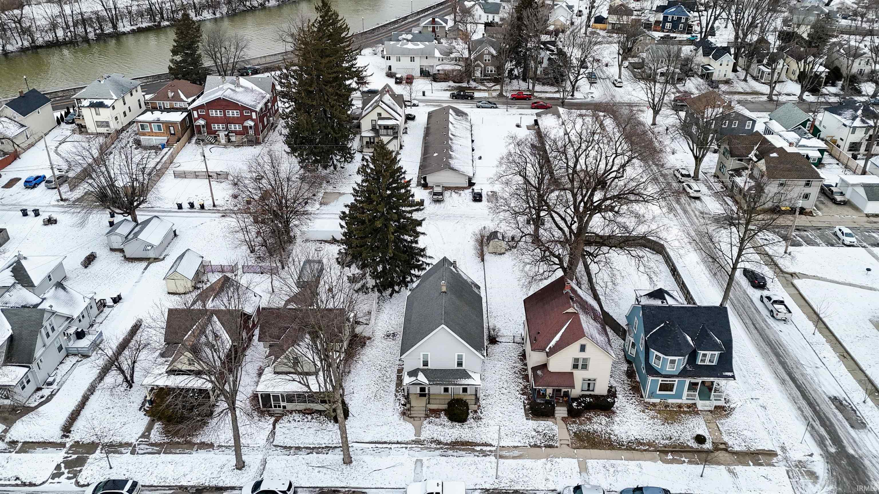 Snowy aerial view with a residential view and a water view