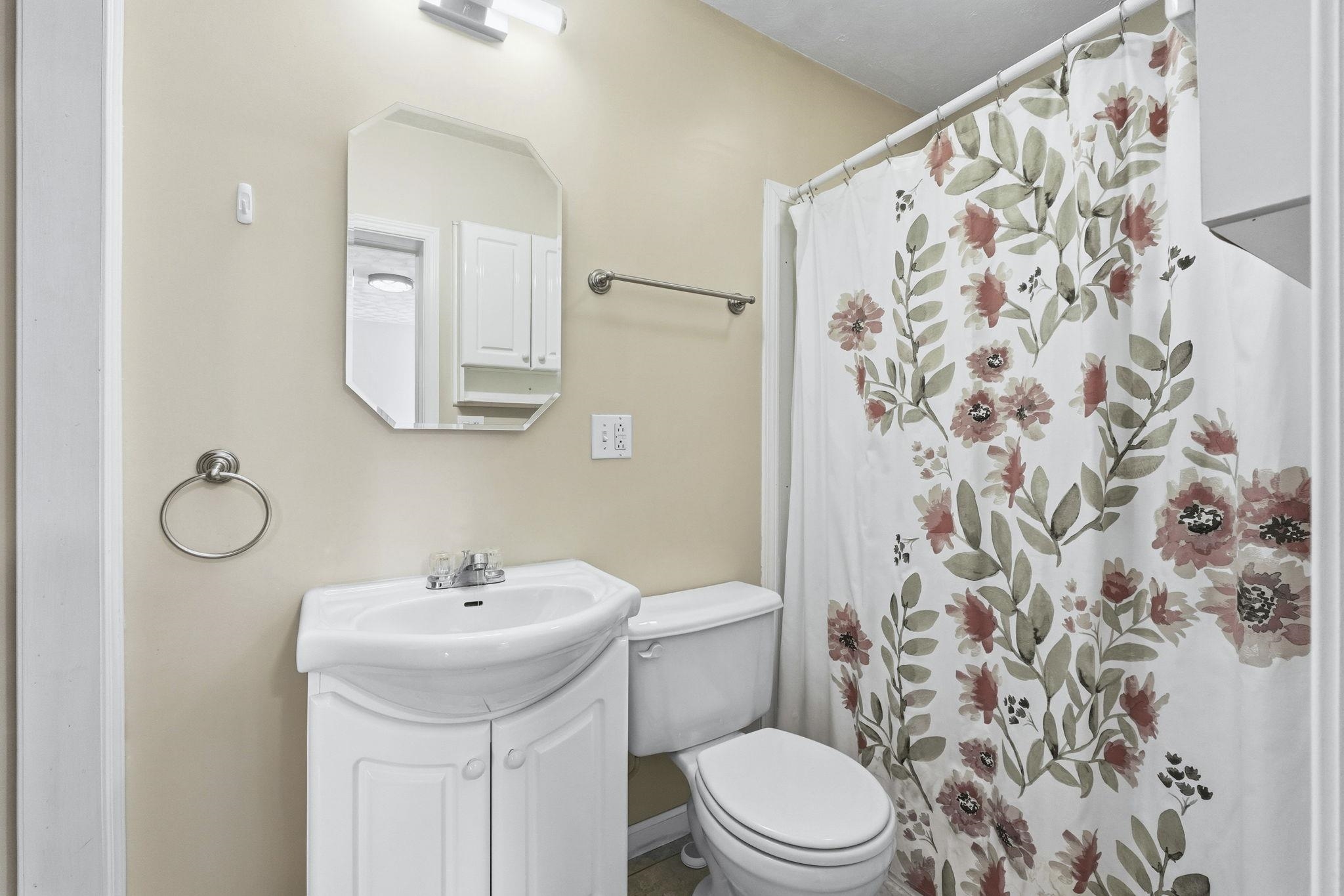 Full bath with a stand up shower.