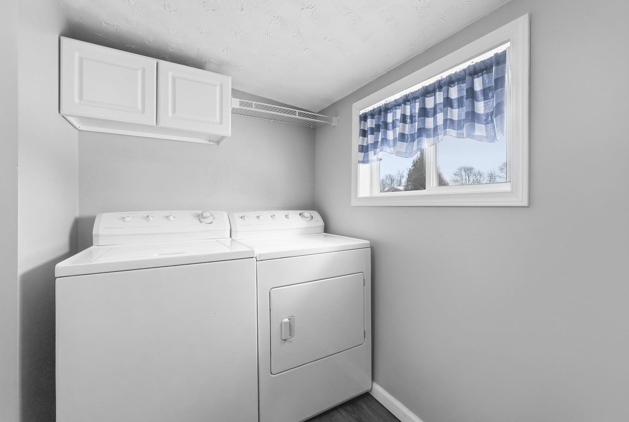 Laundry room featuring washer and dryer and cabinet space