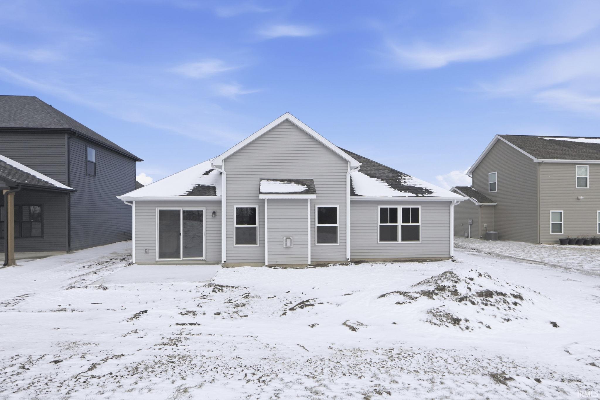 View of snow covered back of property