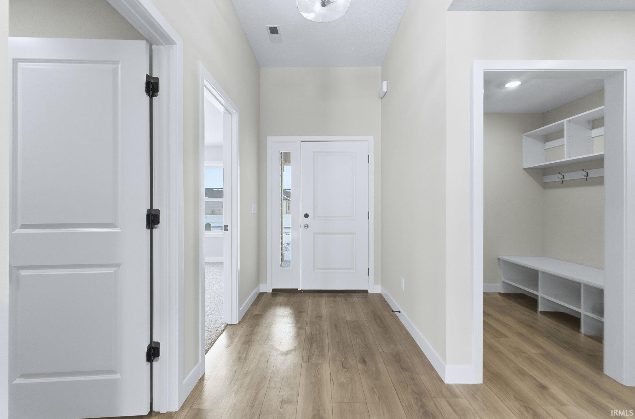 Entryway featuring light wood-type flooring and baseboards