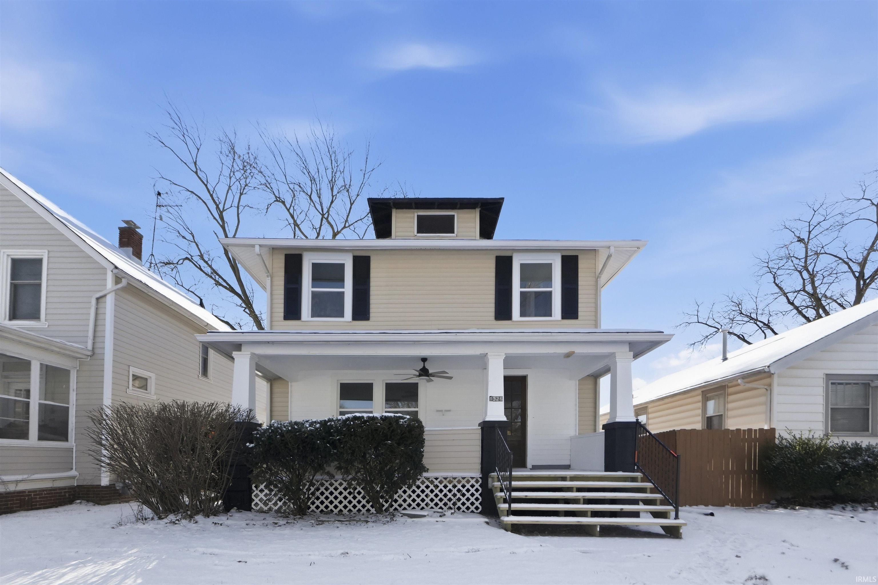 Traditional style home featuring a porch and a ceiling fan