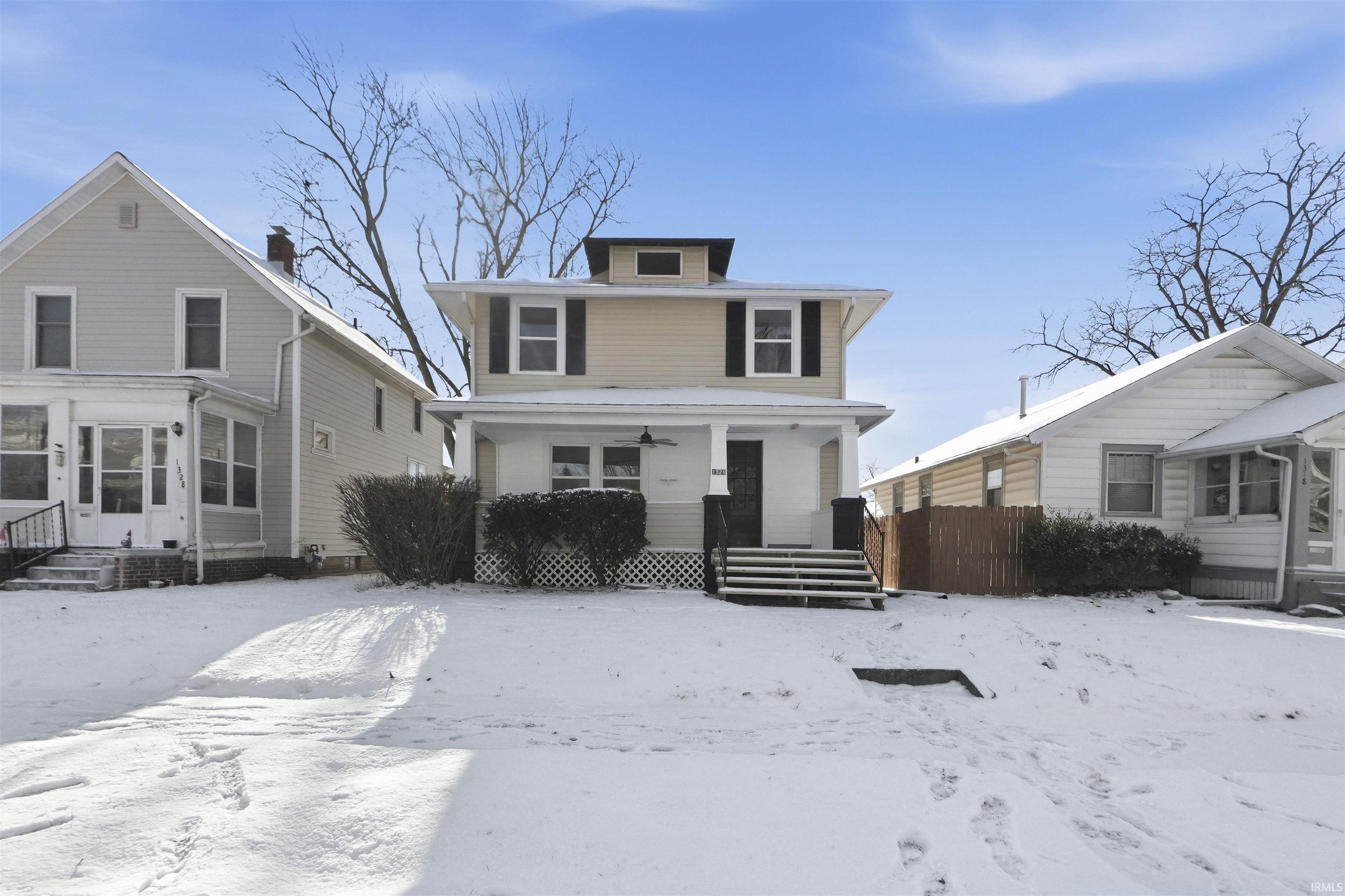 American foursquare style home with a ceiling fan