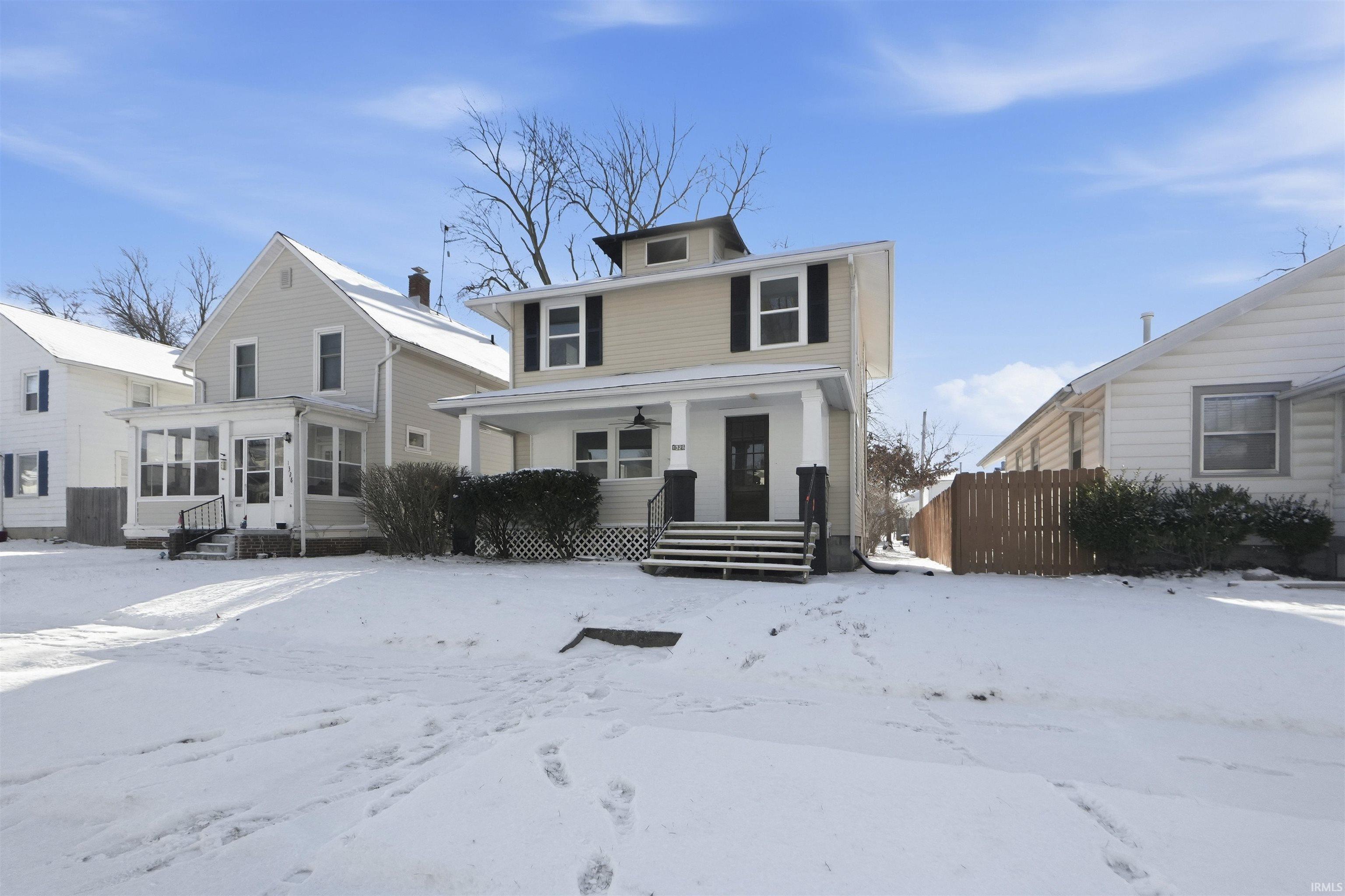 American foursquare style home with a sunroom