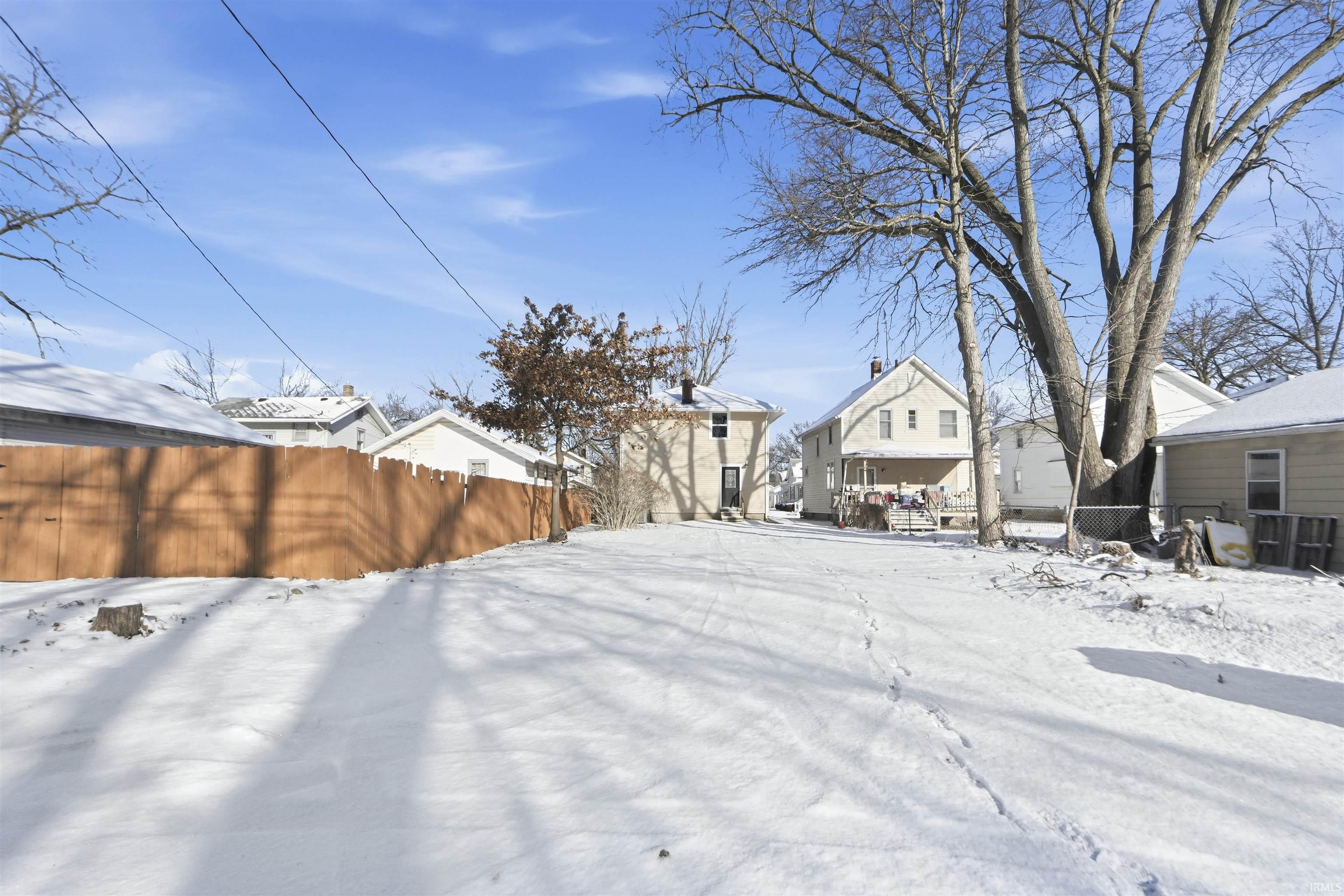 Snowy yard with a residential view