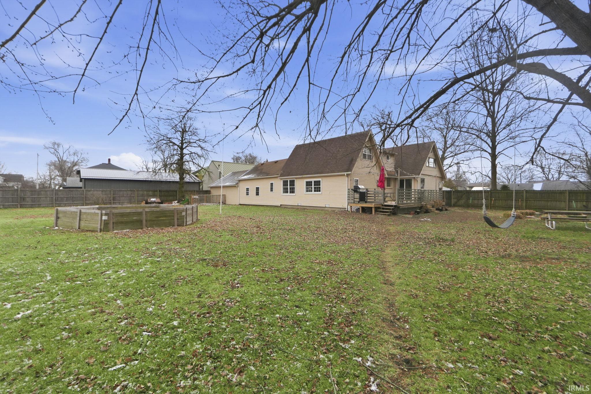 Back of property featuring a wooden deck