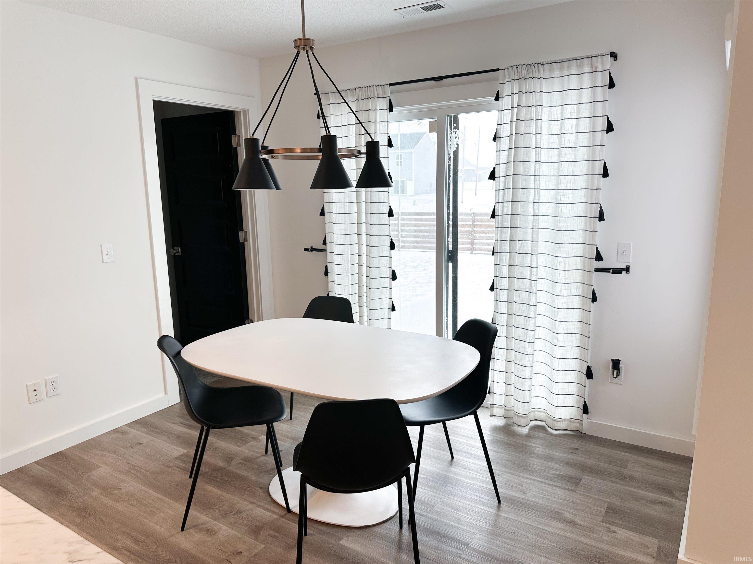 Dining room with light wood-style flooring and baseboards