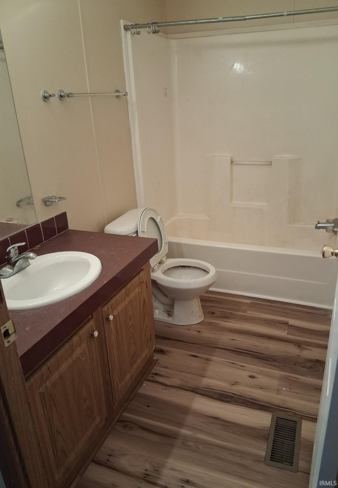 Bathroom with vanity, new vinyl plank flooring, and shower / bath combination