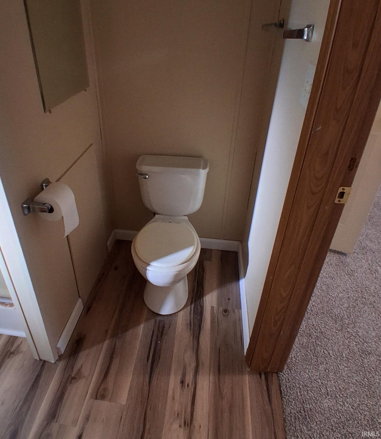 Master Bathroom featuring toilet and vinyl plank floors