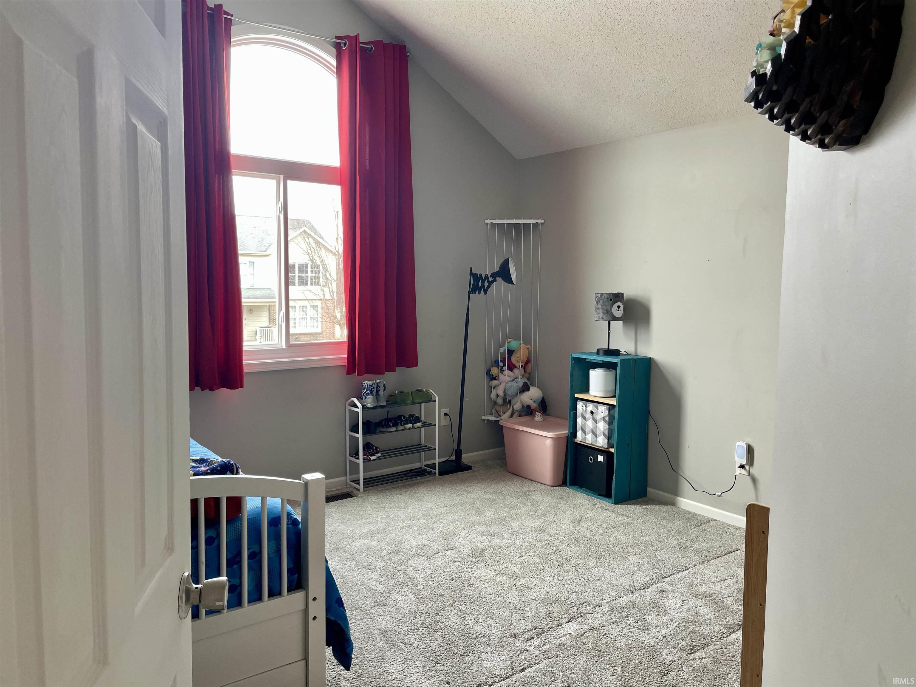 Carpeted bedroom featuring baseboards