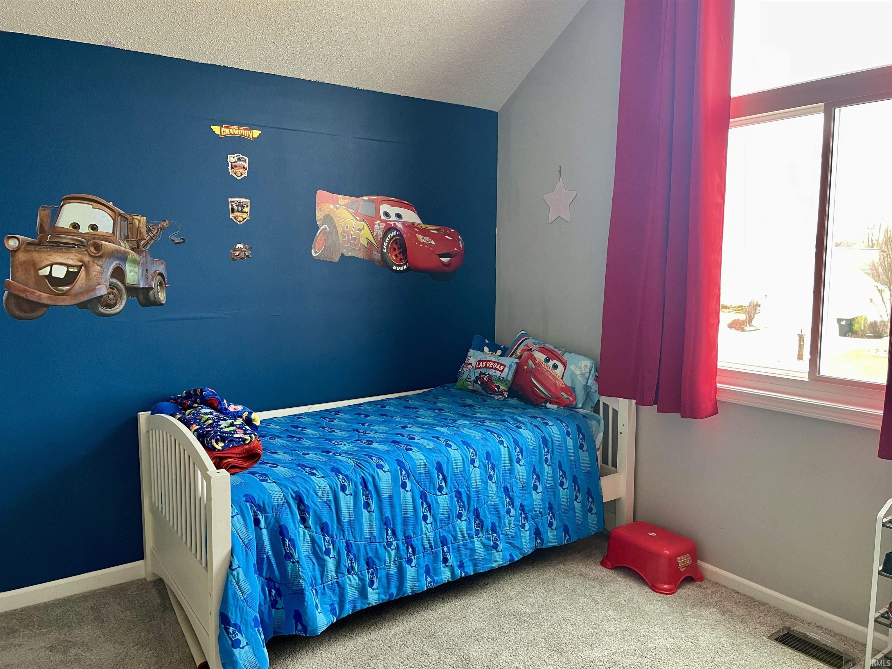 Bedroom with carpet floors and baseboards