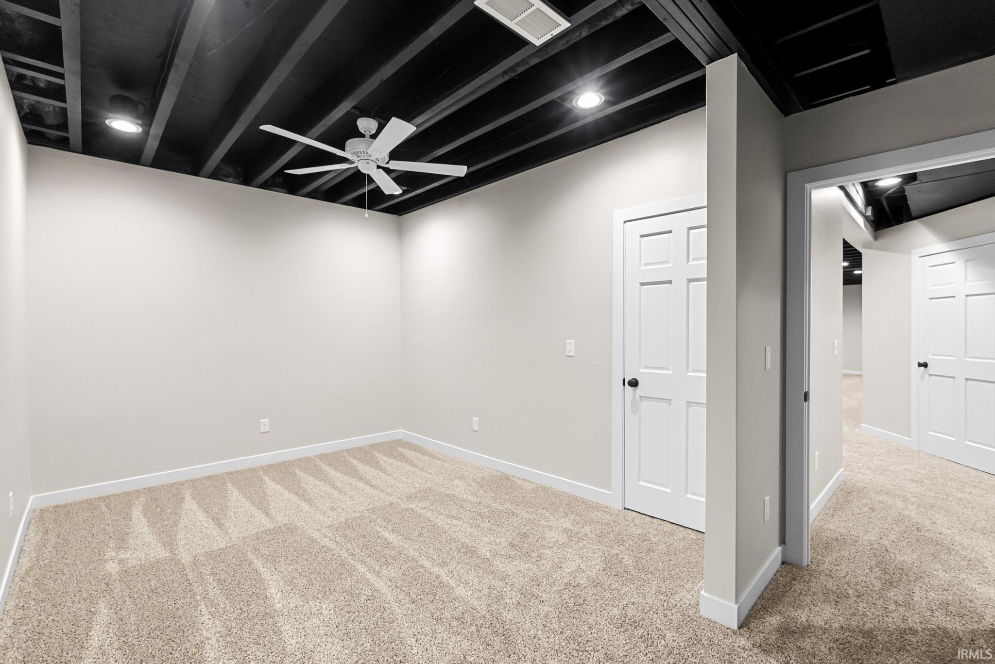 Finished basement featuring carpet floors and recessed lighting
