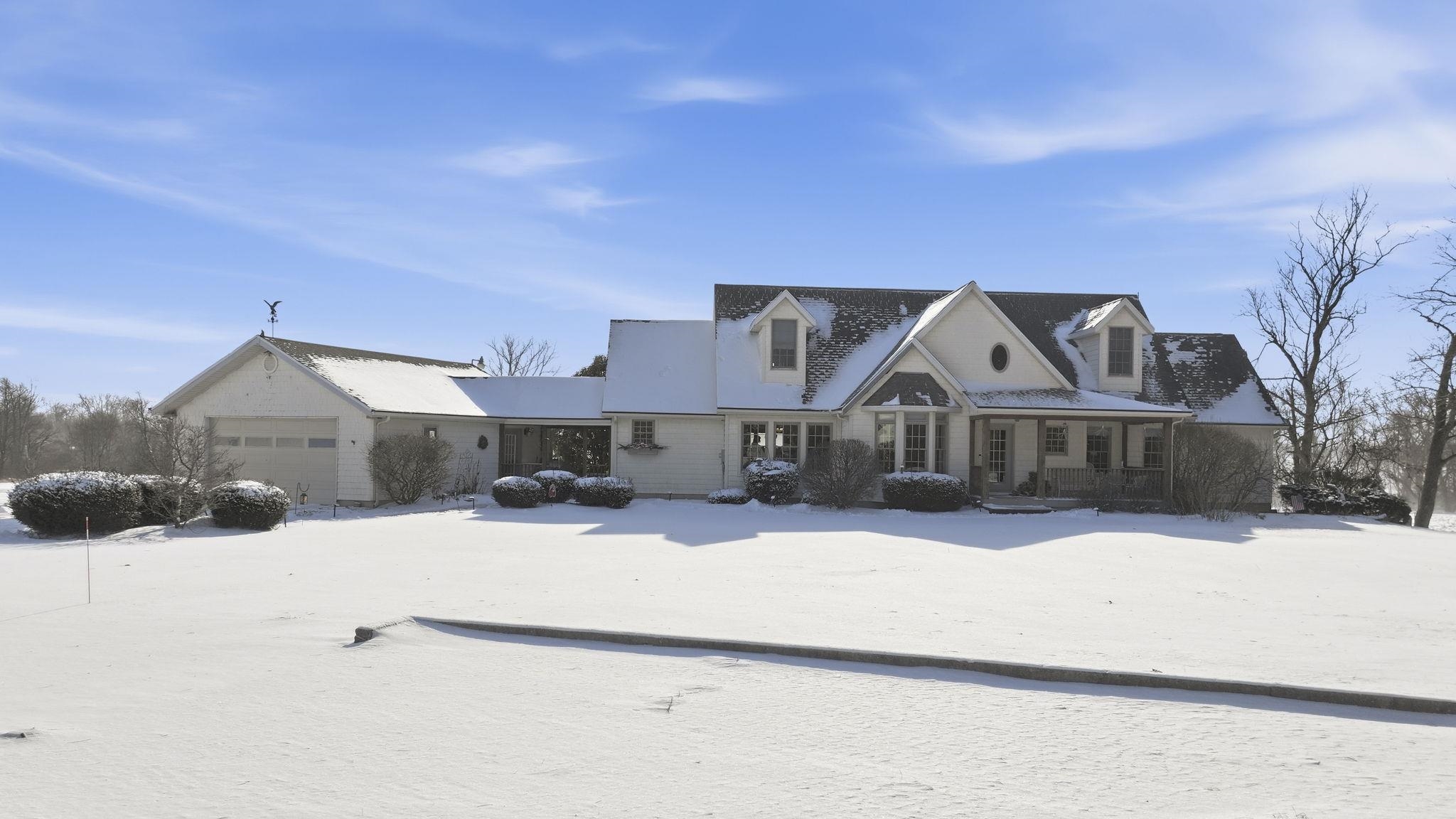 View of front facade with a porch and an attached garage