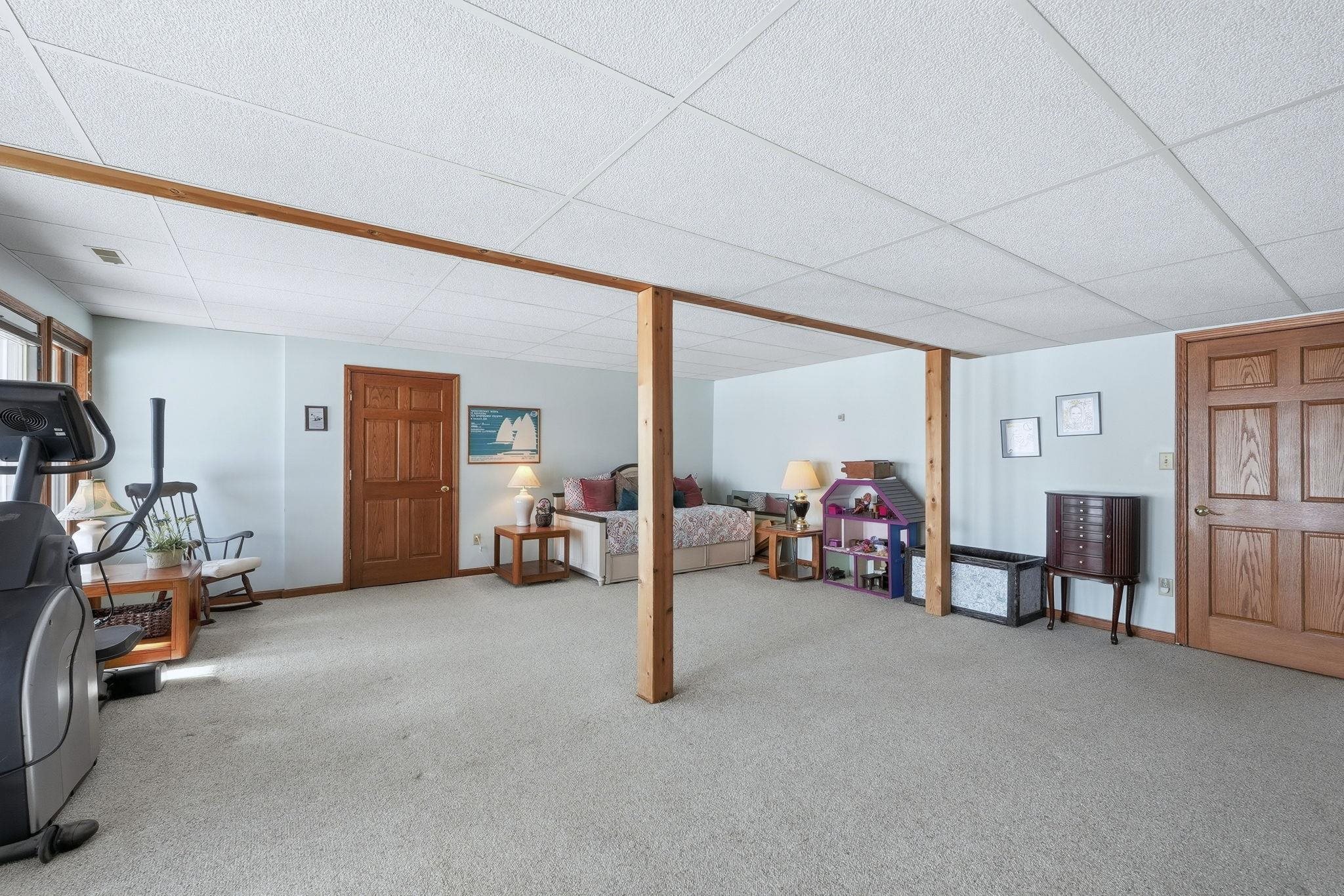 Finished basement featuring carpet and a paneled ceiling